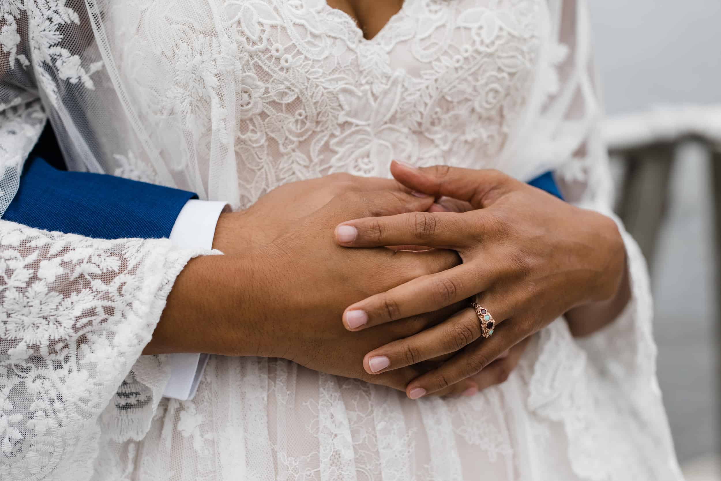 Bride and grooms hands and engagement ring at the Peekskill waterfront before a Hudson Valley Wedding at The Dramatic Hall in Peekskill New York
