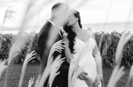 Black and White photo of bride and groom in flowers at Hudson Valley Wedding at Green Tree Country Club in New Rochelle