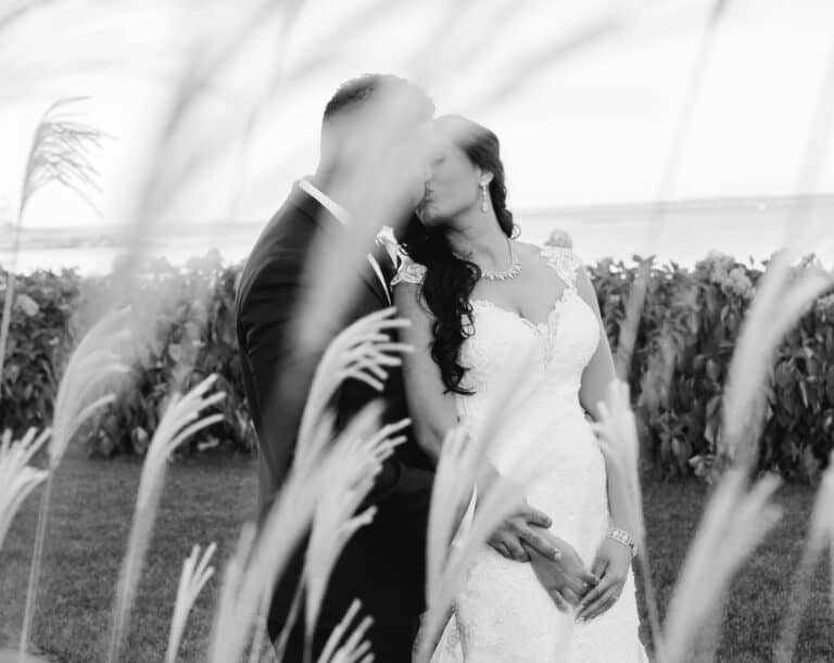 Black and White photo of bride and groom in flowers at Hudson Valley Wedding at Green Tree Country Club in New Rochelle
