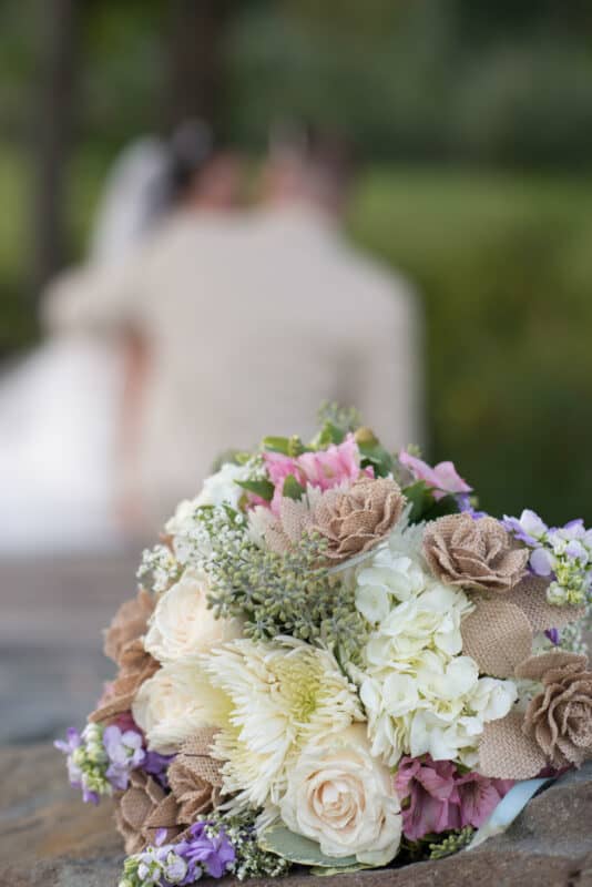 Bouquet on bridge at Hudson Valley Wedding at Nostranos Vineyard
