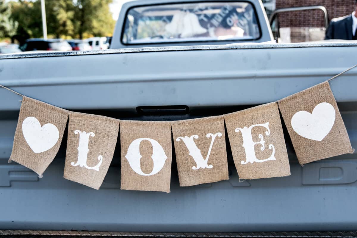 Love banner on a pickup truck before a Hudson Valley Wedding At West Hills Country Club In Middletown, New York