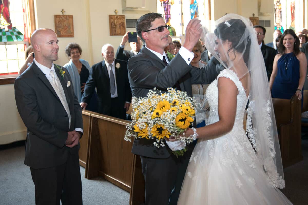 Father of bride lifts veil at a Hudson Valley Wedding At West Hills Country Club In Middletown, New York