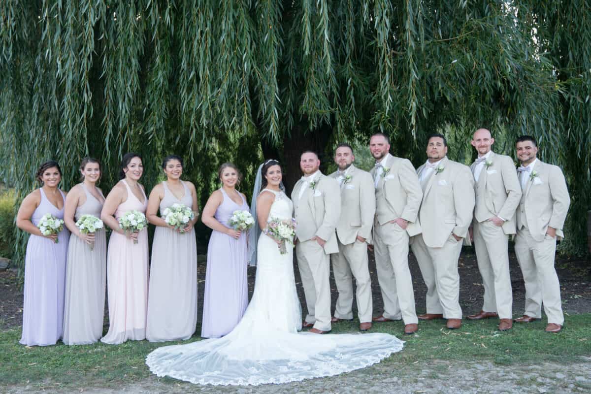 Bridal Party pose by a tree at Hudson Valley Wedding at Nostranos Vineyard