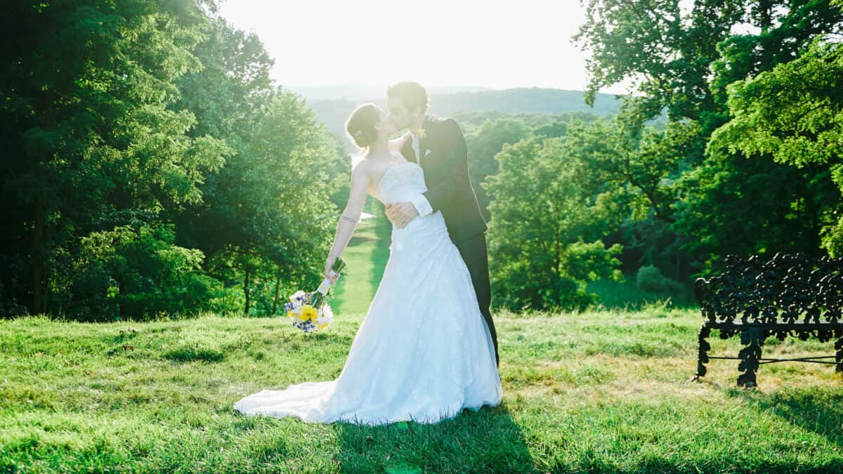 Groom dips and kisses bride after Hudson Valley Ceremony At Locust Grove in Poughkeepsie