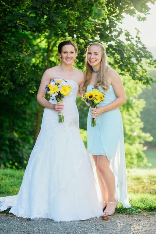 Bride poses with maid of honor after Hudson Valley Ceremony At Locust Grove in Poughkeepsie
