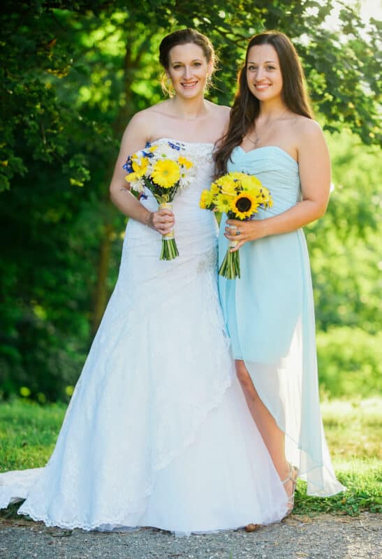 Bride poses with bridesmaid after Hudson Valley Ceremony At Locust Grove in Poughkeepsie