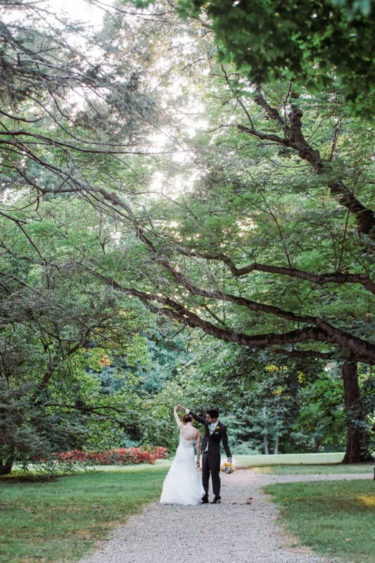 Groom twirls bride after Hudson Valley Ceremony At Locust Grove in Poughkeepsie