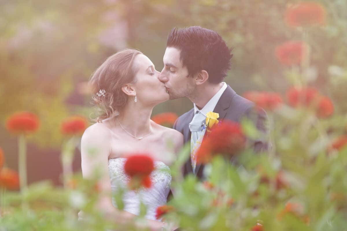 Bride and groom kiss in Garden after Hudson Valley Ceremony At Locust Grove in Poughkeepsie
