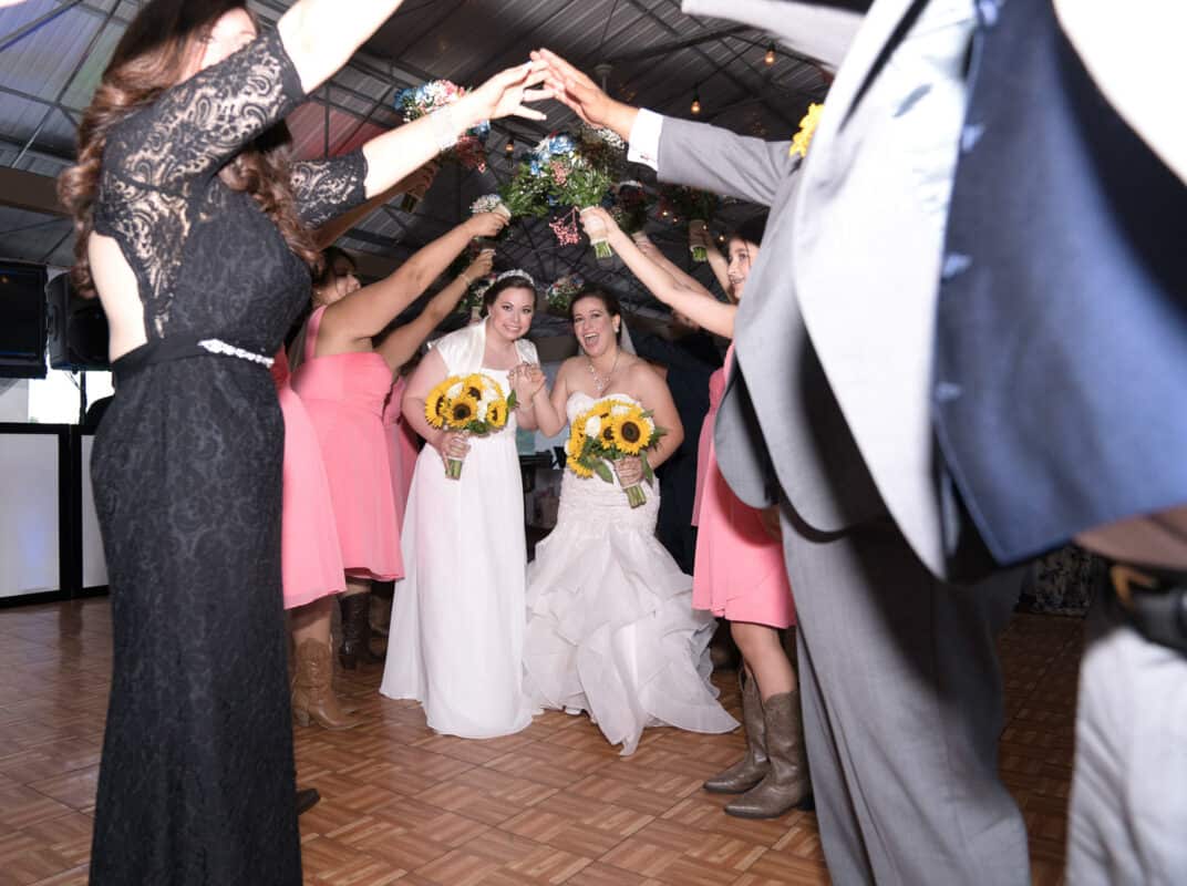 Brides going through tunnel at Hudson Valley same sex wedding At Lippincott Manor in Walkill New York