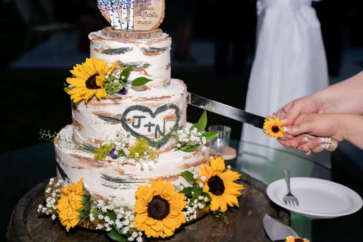 Bride cuts Wedding Cake at Hudson Valley same sex wedding At Lippincott Manor in Walkill New York