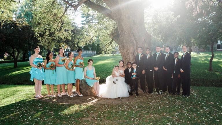 Bride and groom posing with bridal party by a tree at a Albany Wedding at The Factory Eatery