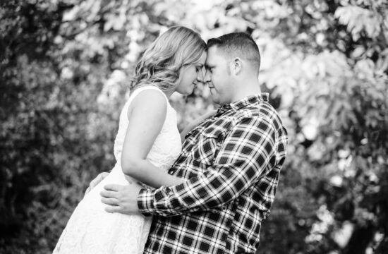 Bride and groom touches forehead at a farm engagement shoot