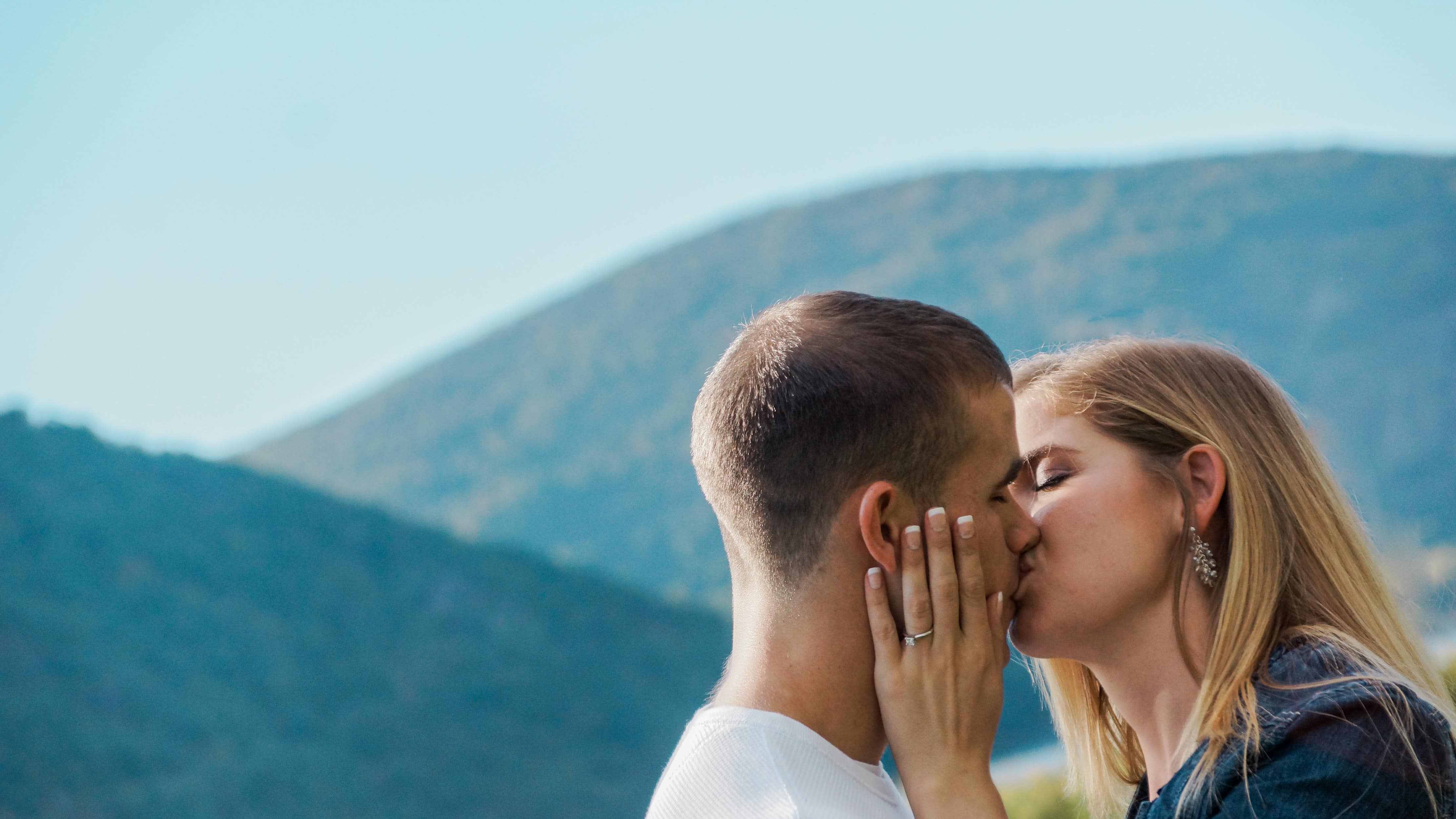 Bride and Groom Kiss by Mountains during a Cold Spring Engagement Shoot in the Hudson Valley