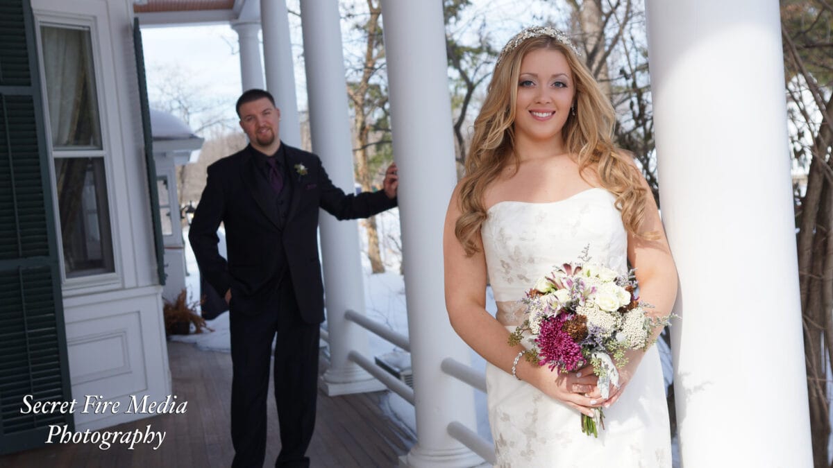Bride and Groom pose on porch before a Hudson Valley wedding at The Caldwell House