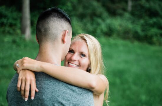 Bride hugs Groom and smiles for an engagement photo in the Hudson Valley
