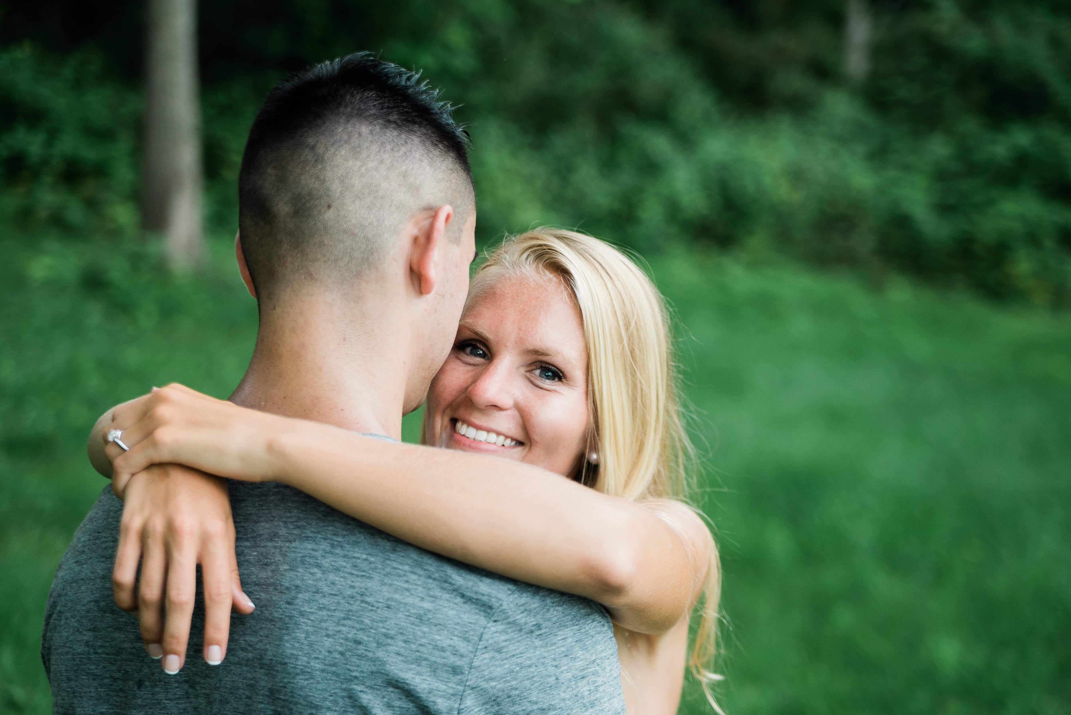 Bride hugs Groom and smiles for an engagement photo in the Hudson Valley
