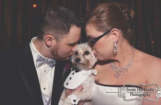 Bride and groom kiss dog at a Hudson Valley Wedding at The Poughkeepsie Grand Hotel