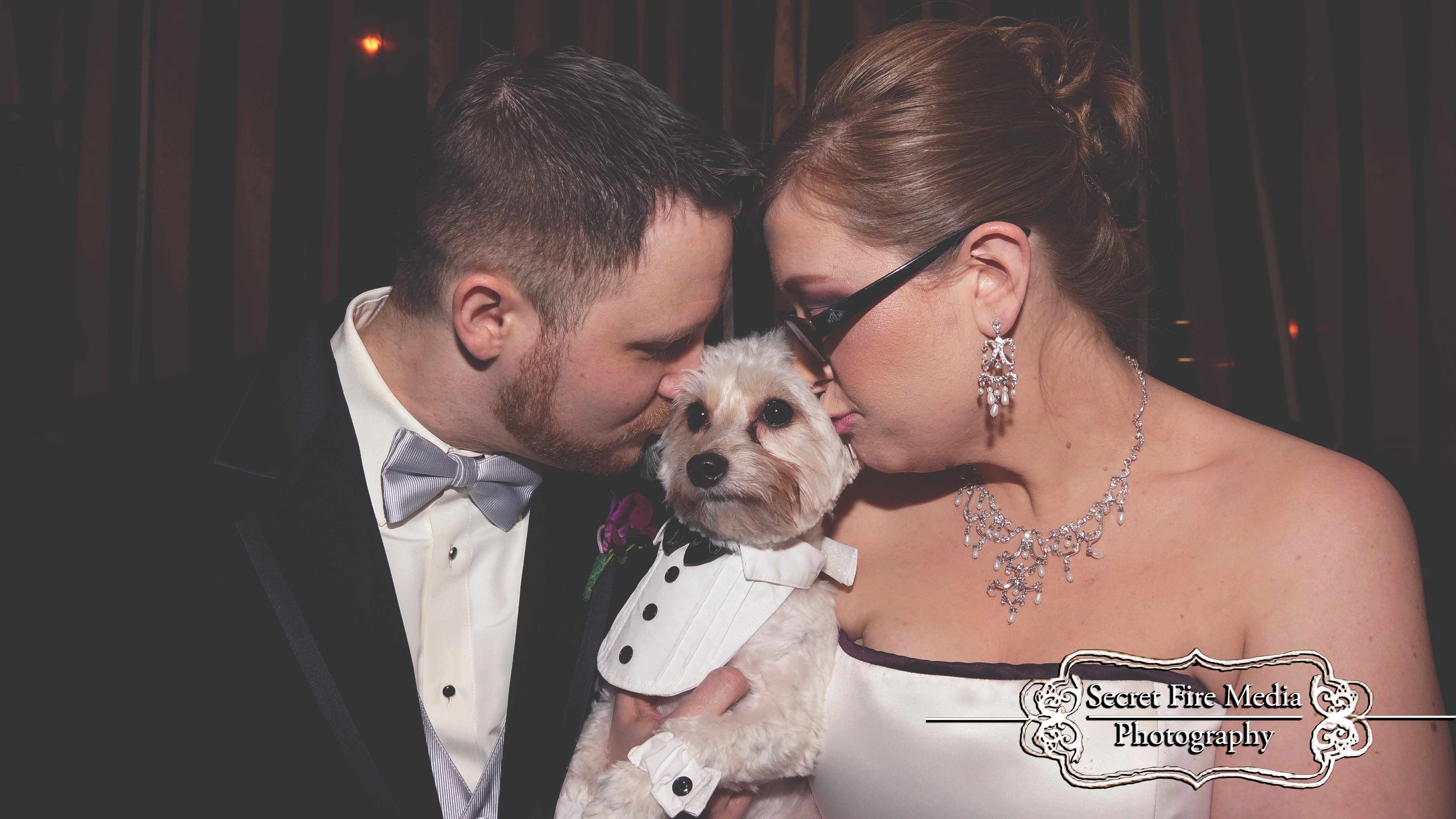 Bride and groom kiss dog at a Hudson Valley Wedding at The Poughkeepsie Grand Hotel