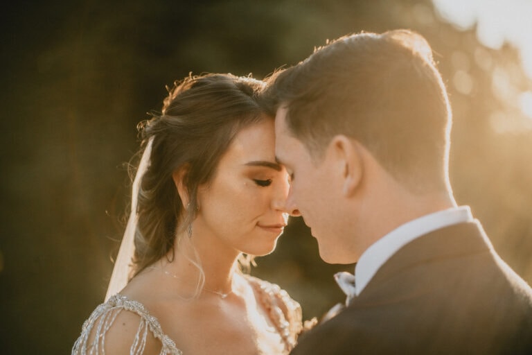 Bride and Groom touch foreheads by Hudson River at Sunset at a Hudson Valley Wedding for Locust Grove Estate Wedding Photography