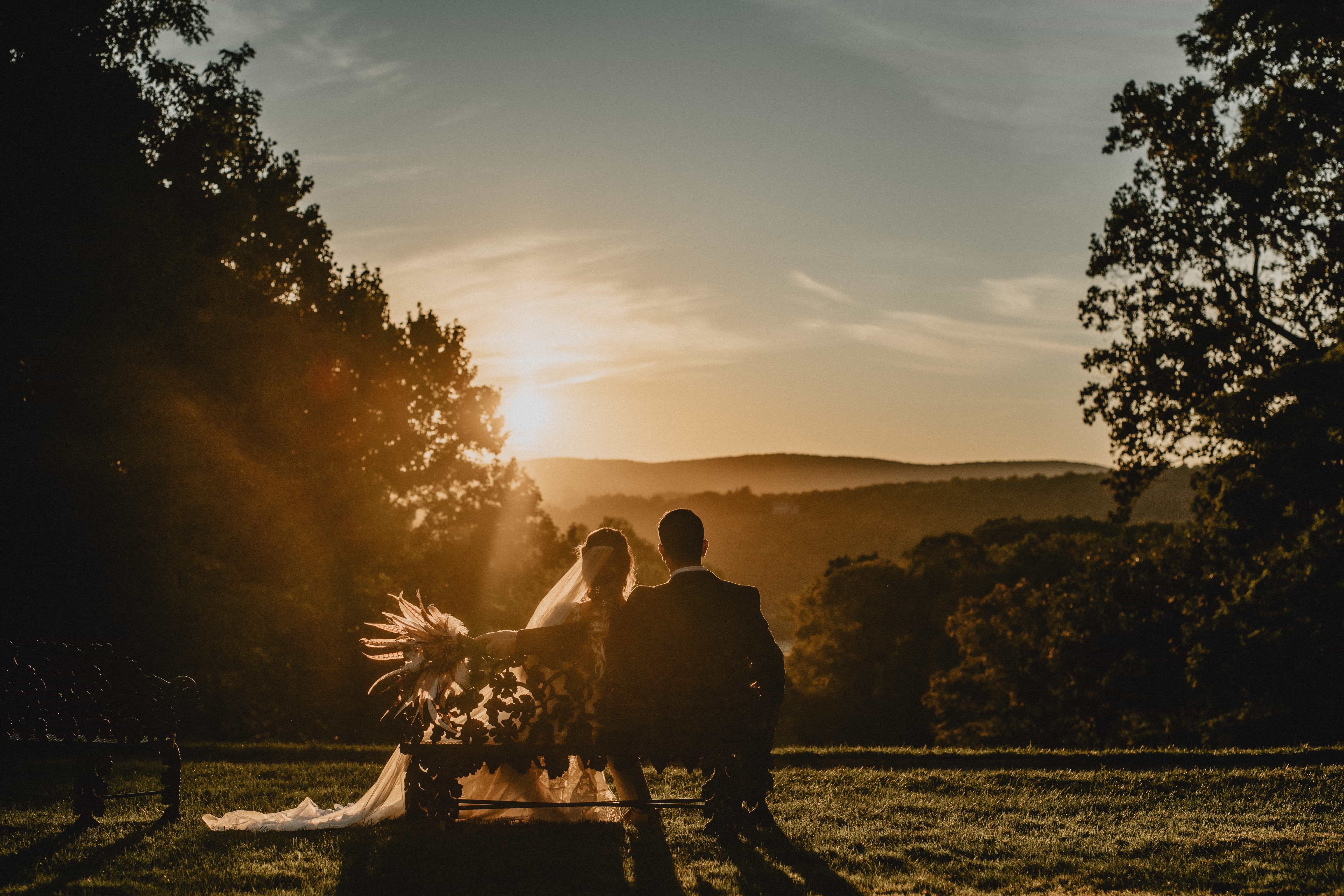 Bride and Groom sit on a bench at Sunset at a Hudson Valley Wedding for Locust Grove Estate Wedding Photography
