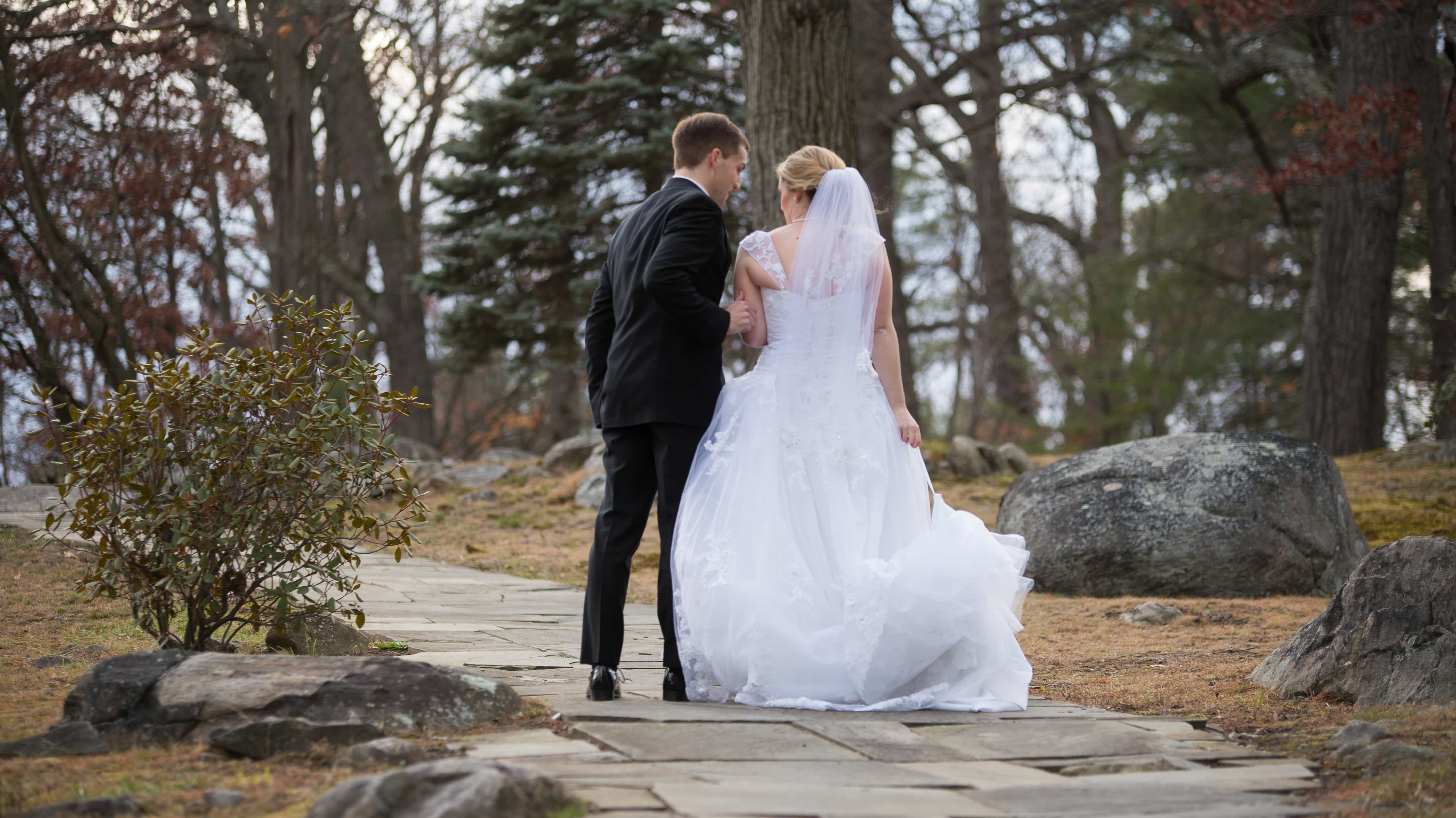 Bride and groom look into each others eyes and pose by trees at a Hudson Valley Wedding for Thayer Hotel Wedding Photos