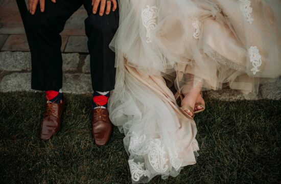 Bride and grooms shoes by lake at a Hudson Valley Wedding at Villa Barone Hilltop Manor in Mahopac