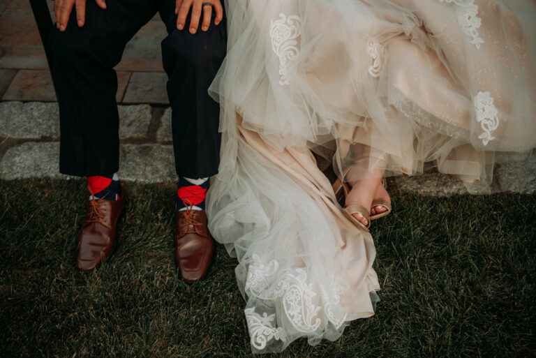 Bride and grooms shoes by lake at a Hudson Valley Wedding at Villa Barone Hilltop Manor in Mahopac