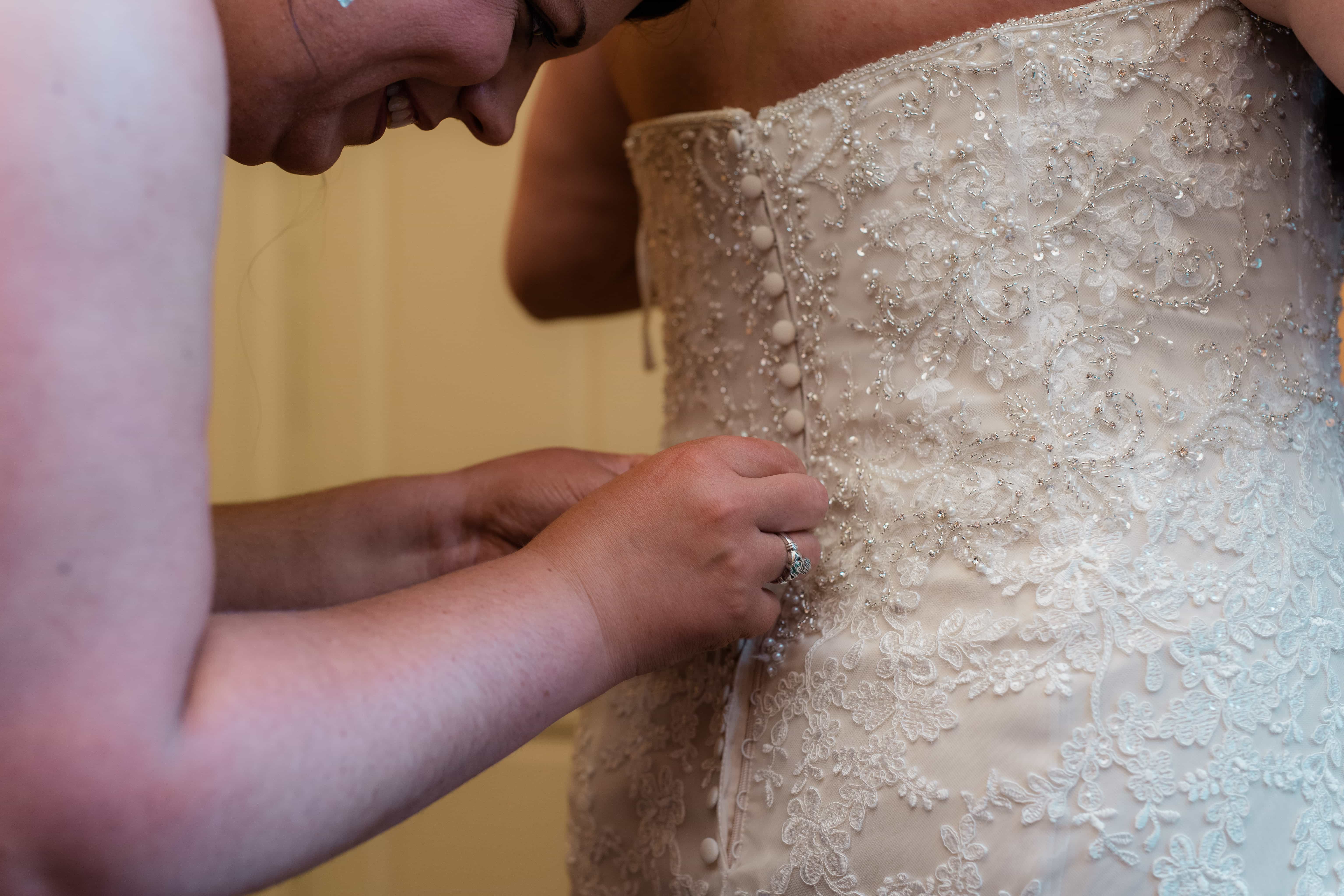 Bride gets into wedding dress at a Hudson Valley Wedding at Brotherhood Winery