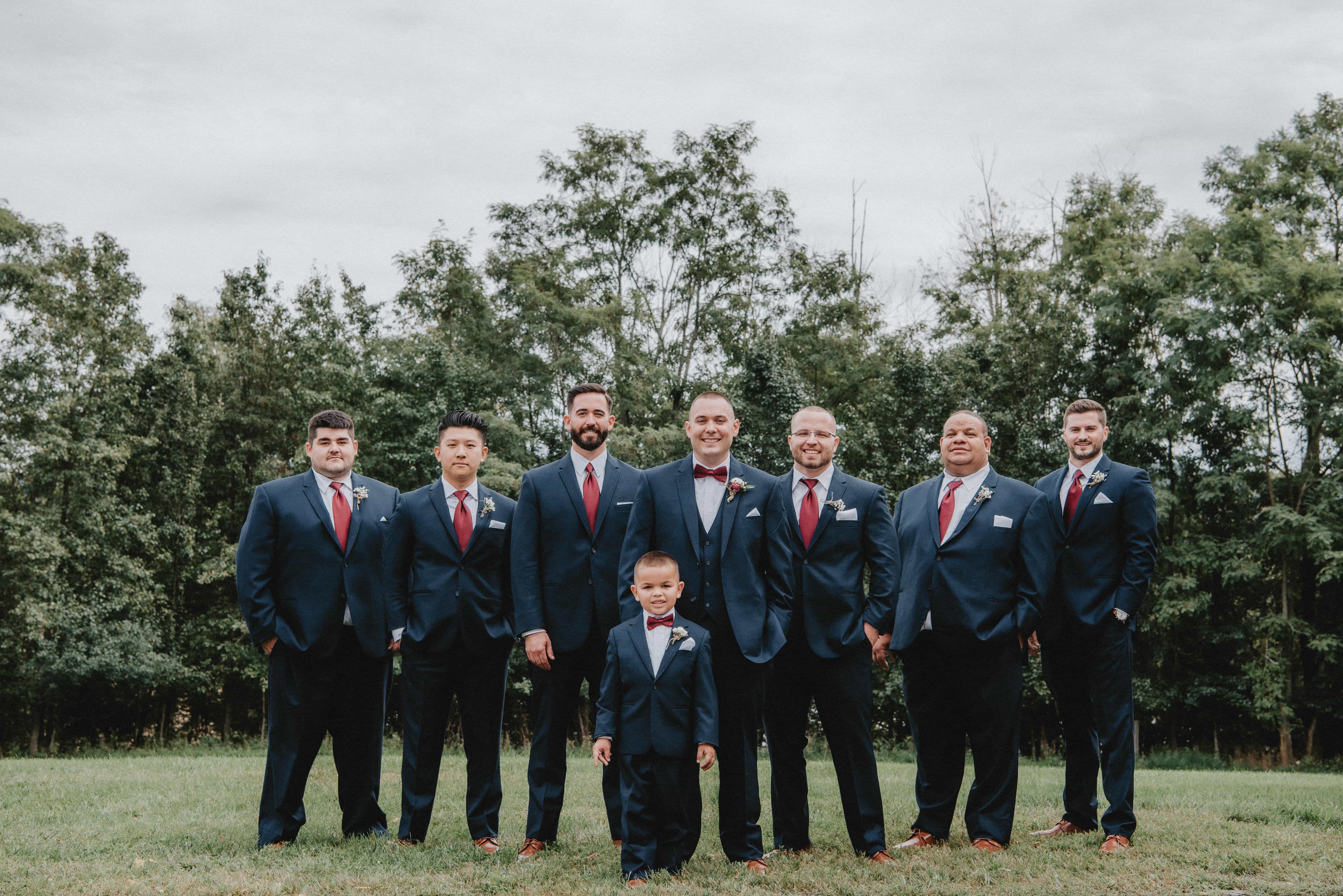 Groom poses with groomsmen and ring bearer at a Hudson Valley Wedding at Brotherhood Winery