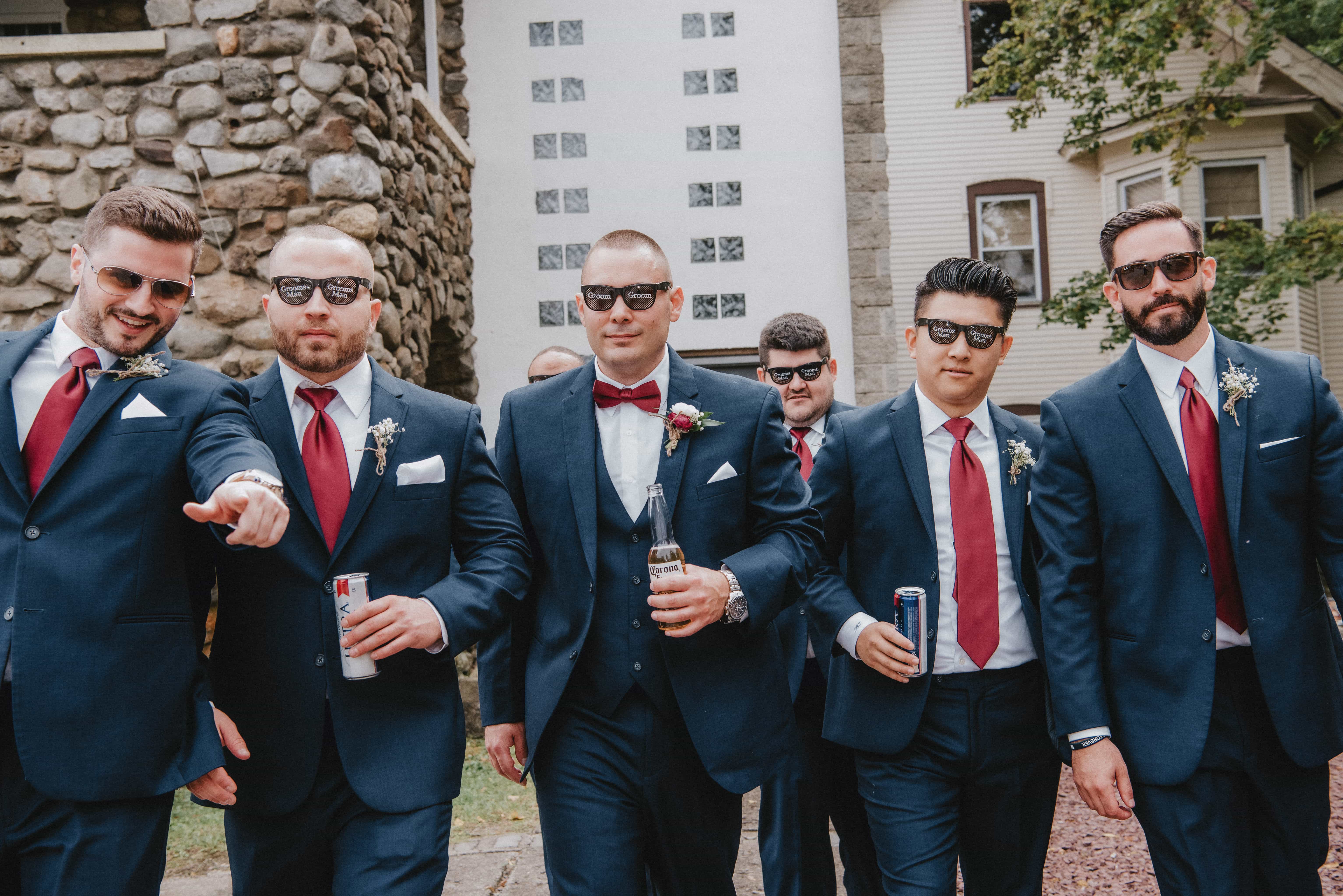 Groom walks with groomsmen at a Hudson Valley Wedding at Brotherhood Winery