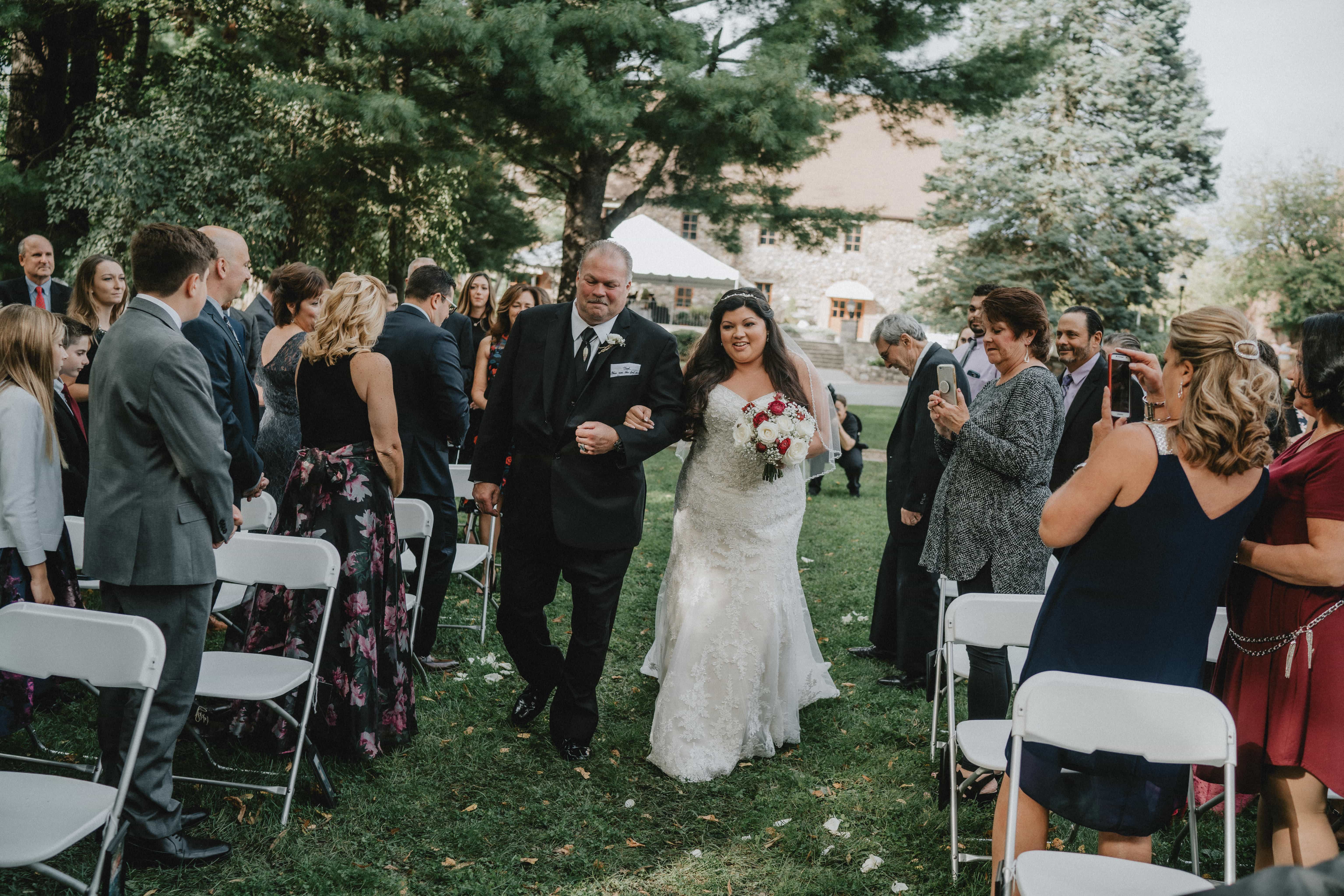 Bride walks down aisle at a Hudson Valley Wedding at Brotherhood Winery