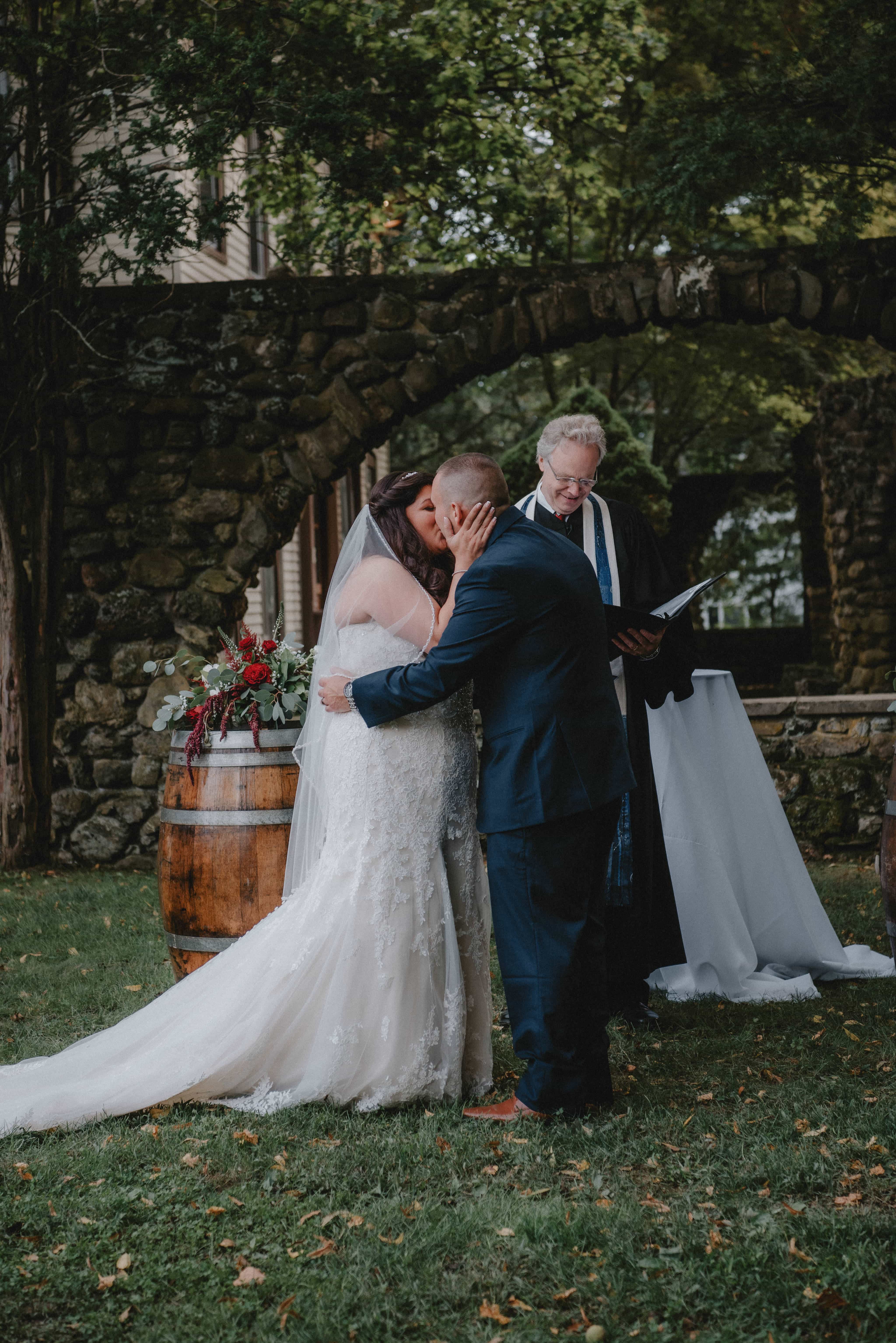 Bride and Groom Kiss during Ceremony at a Hudson Valley Wedding at Brotherhood Winery