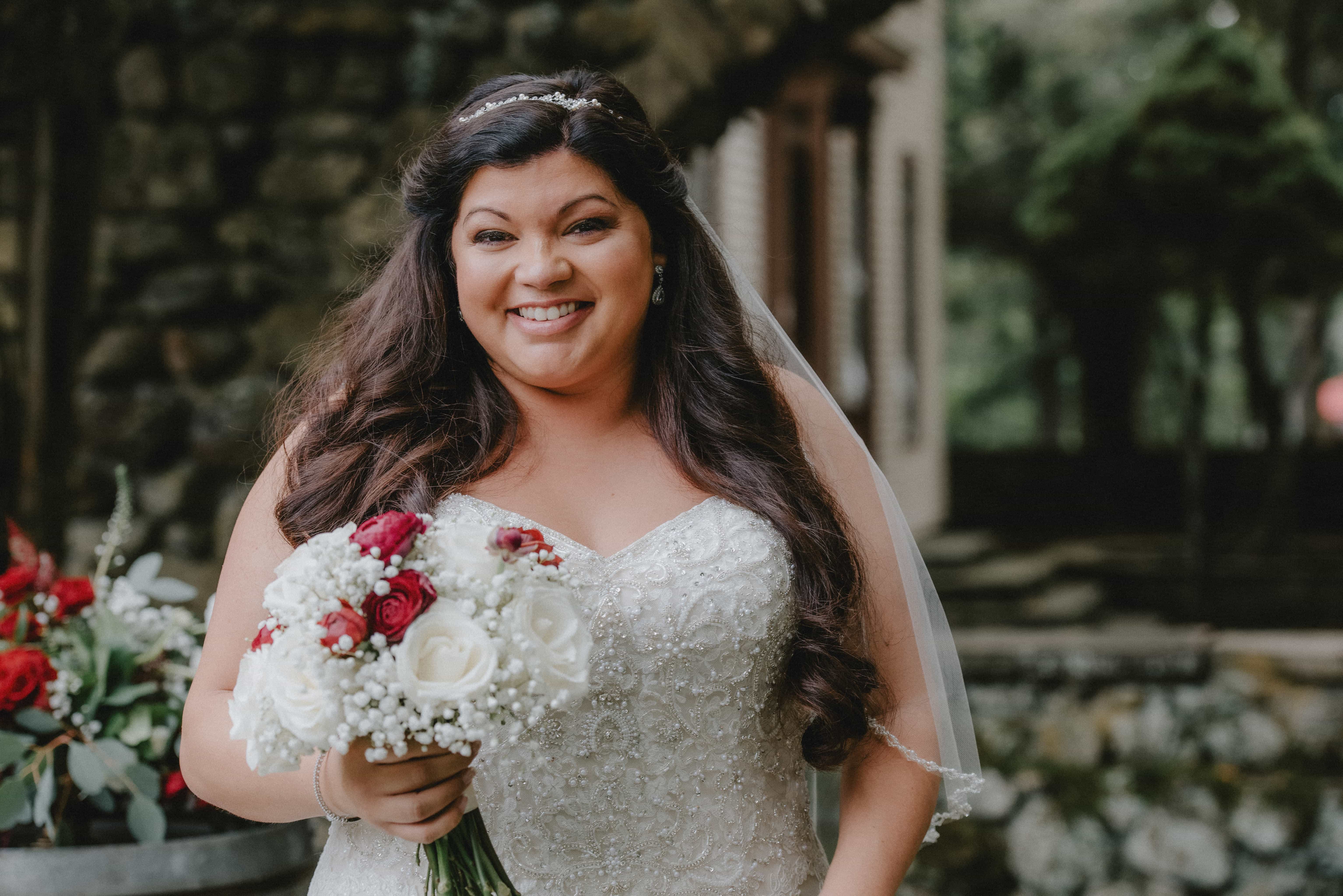Bride poses with bouquet at a Hudson Valley Wedding at Brotherhood Winery