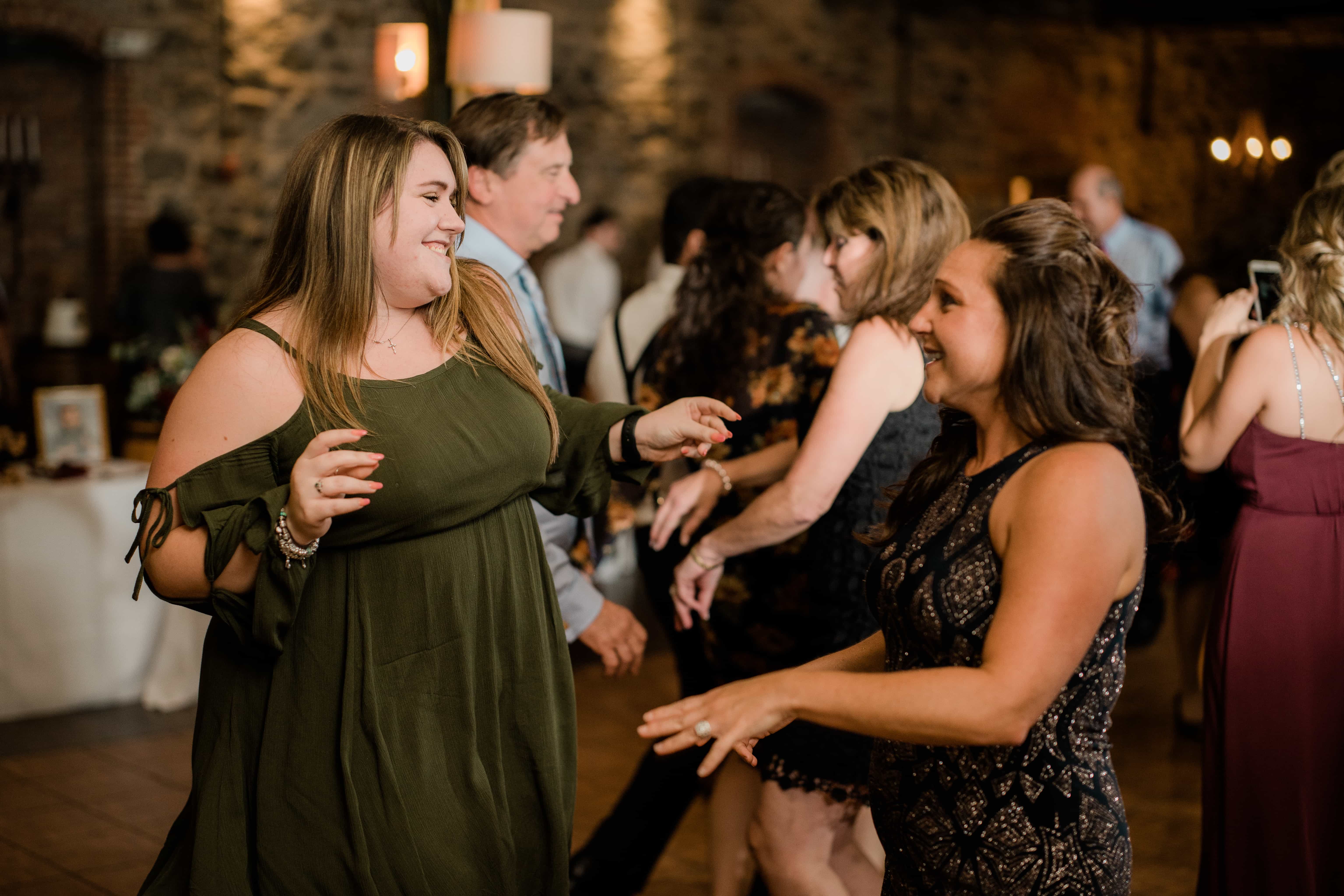 Friends of bride dance at a Hudson Valley Wedding at Brotherhood Winery