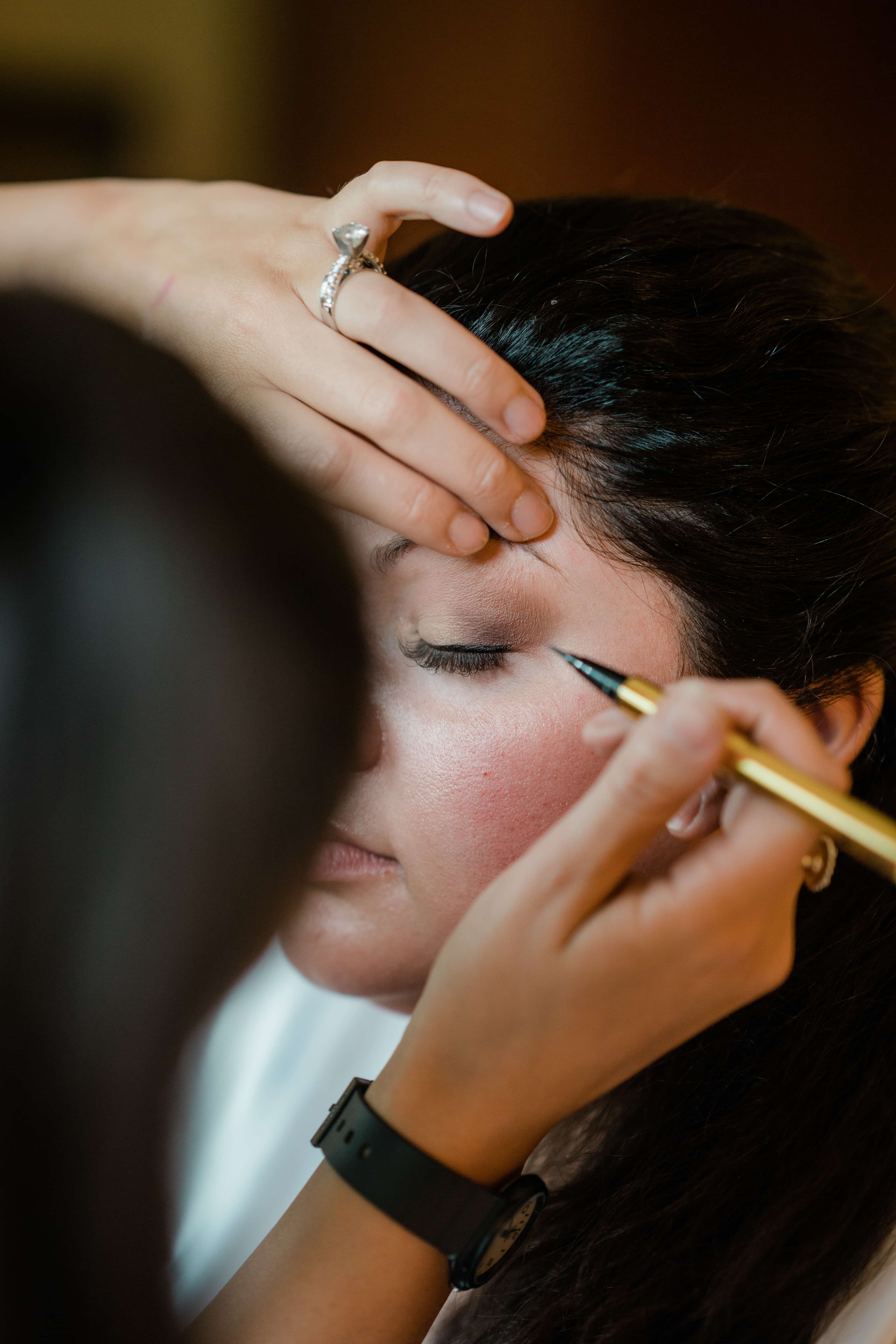 Bride gets makeup while getting ready at a Hudson Valley Wedding at Brotherhood Winery