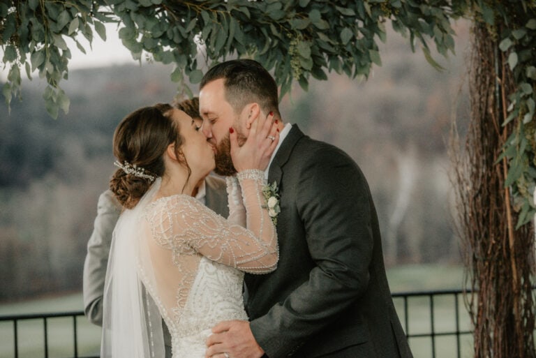 Bride and Grooms first kiss during ceremony at a Hudson Valley Wedding at Hollow Brook Country Club