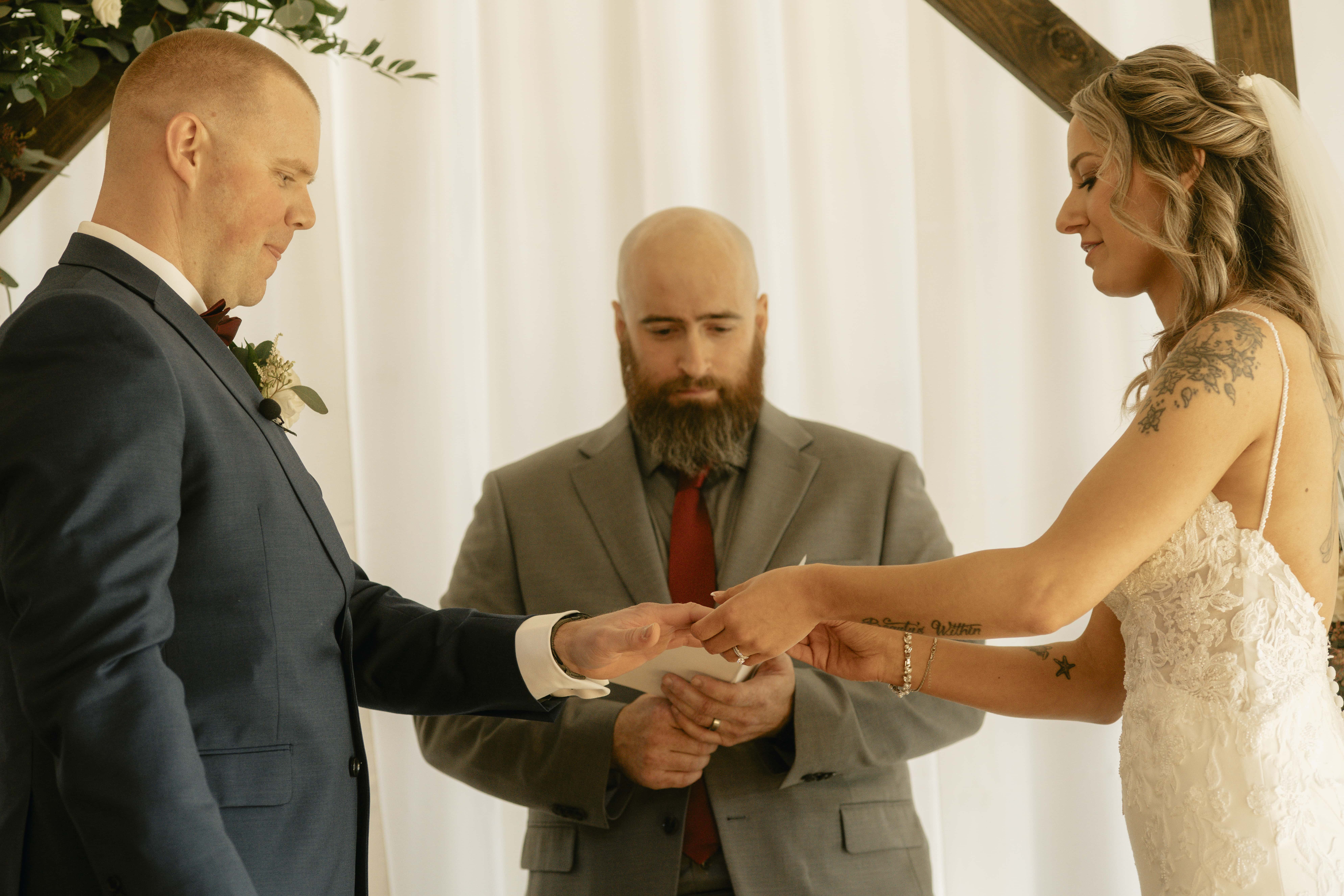 Bride puts ring on grooms finger at a Hudson Valley Wedding at Locust Grove Estate