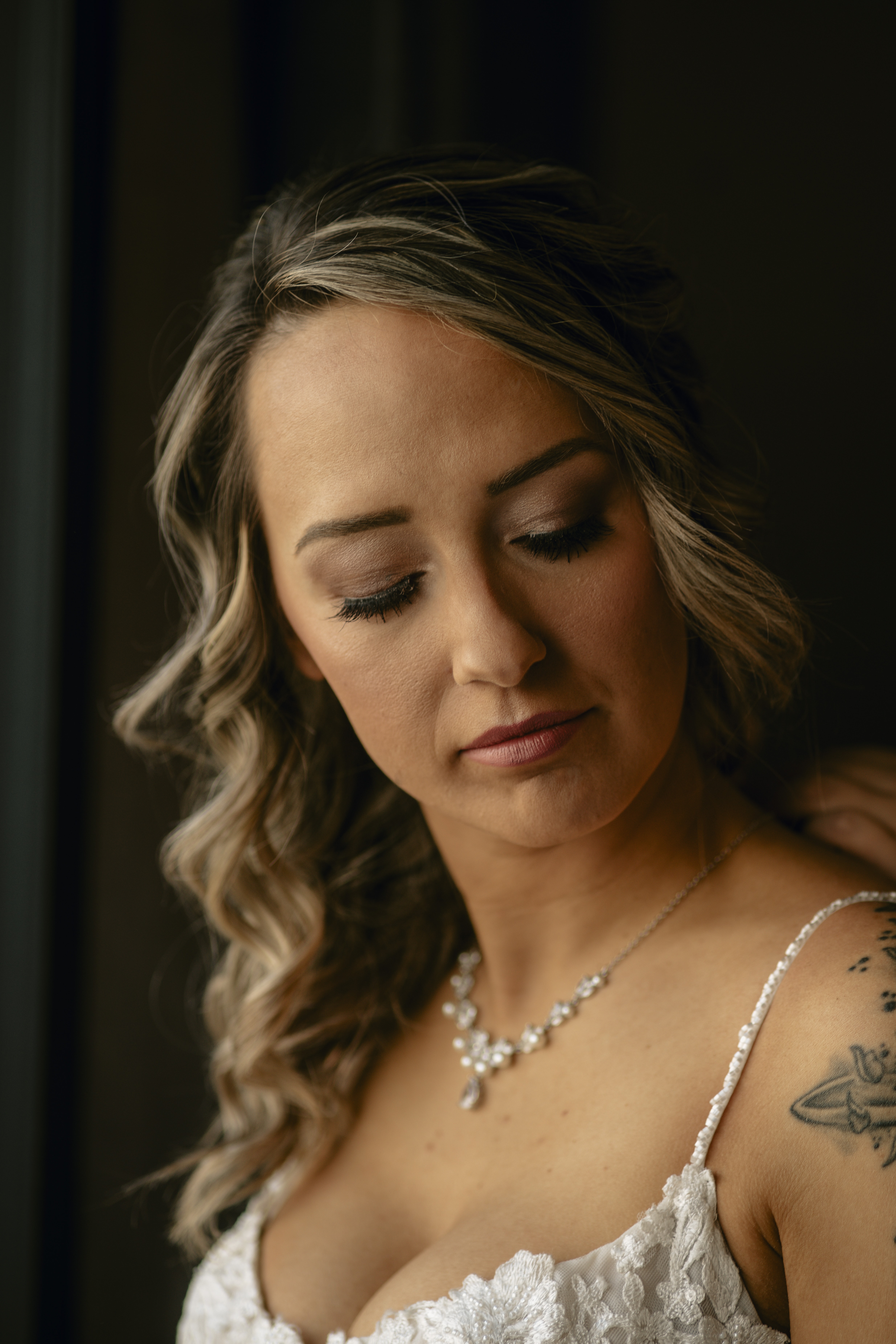 Bride thoughtful and smiles while getting ready at a Hudson Valley Wedding at Locust Grove Estate