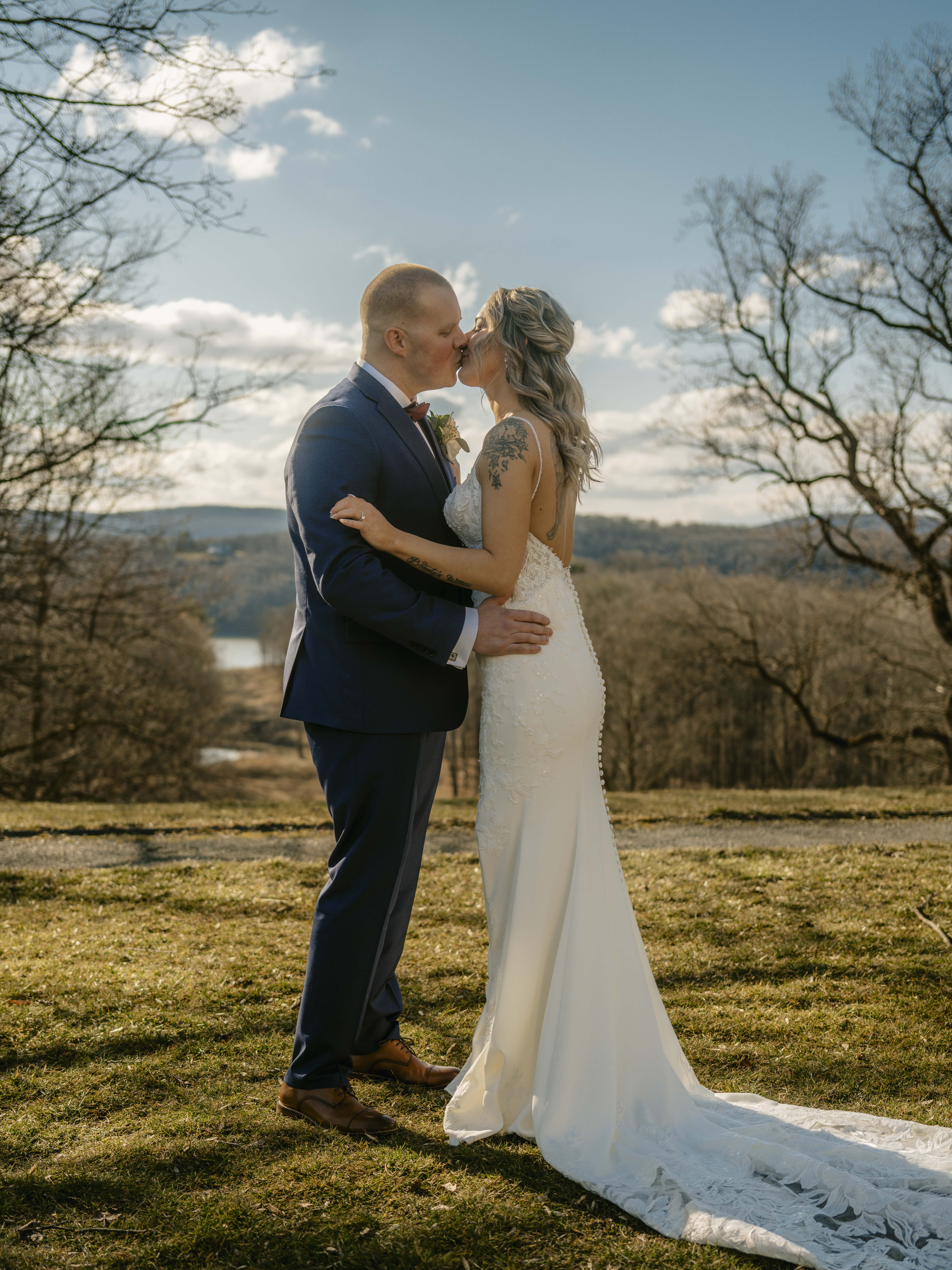 Bride and Groom kiss by valley at a Hudson Valley Wedding at Locust Grove Estate