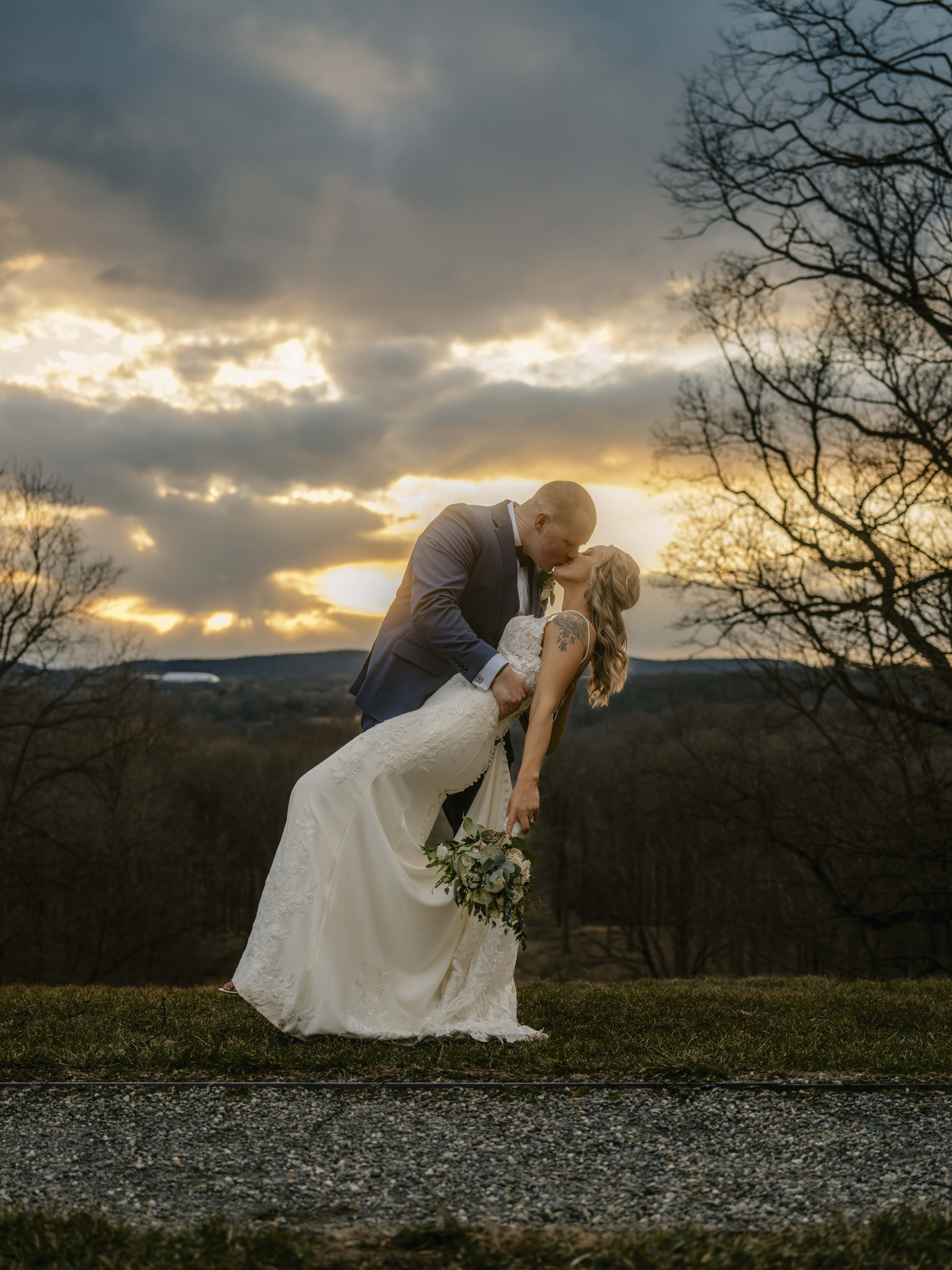 Groom Dips Bride and kisses for a Sunset Photo at a Hudson Valley Wedding at Locust Grove Estate