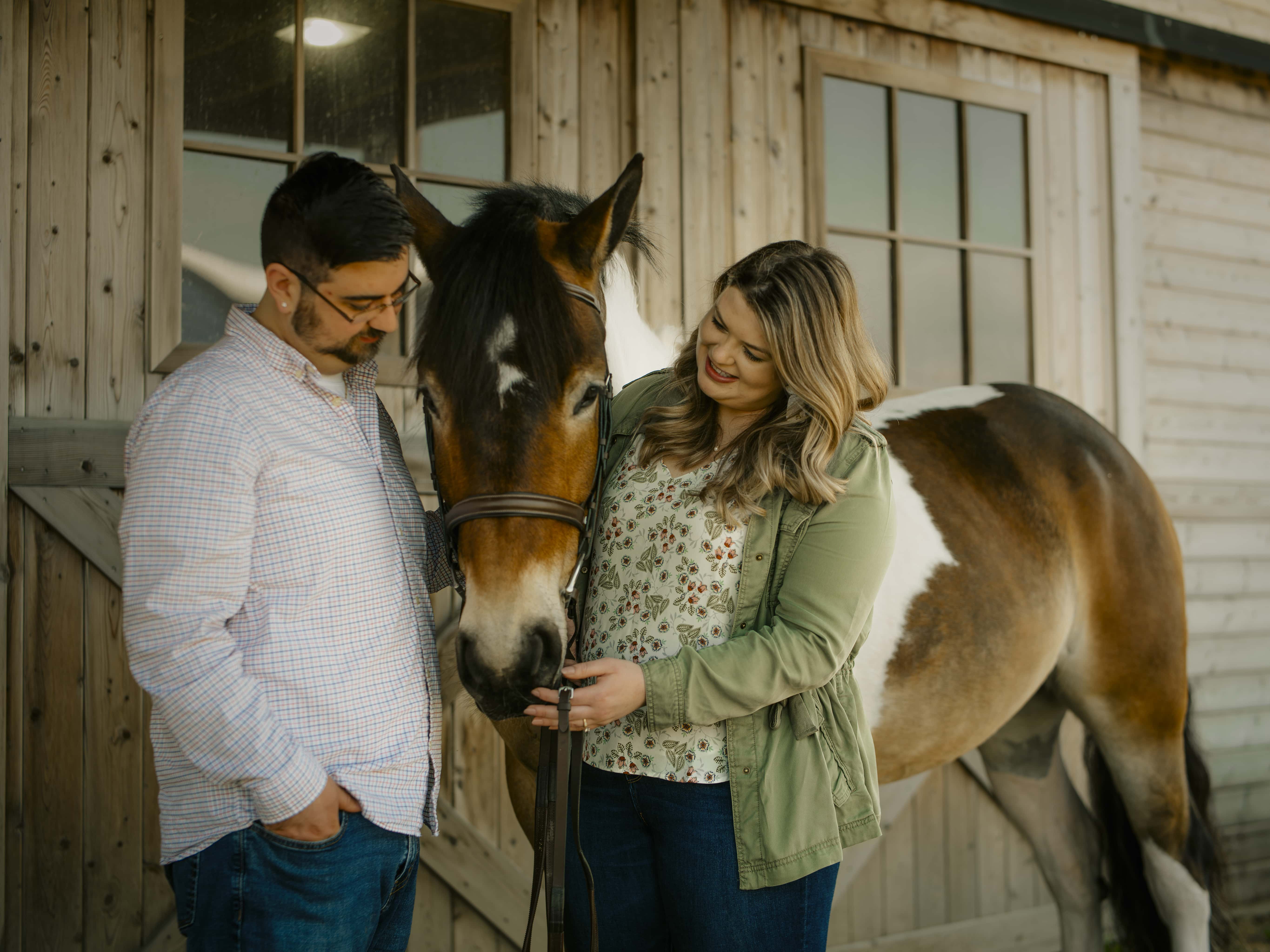 Bride and groom pet horse for Lake Minnewaska Engagement Photos in The Hudson Valley