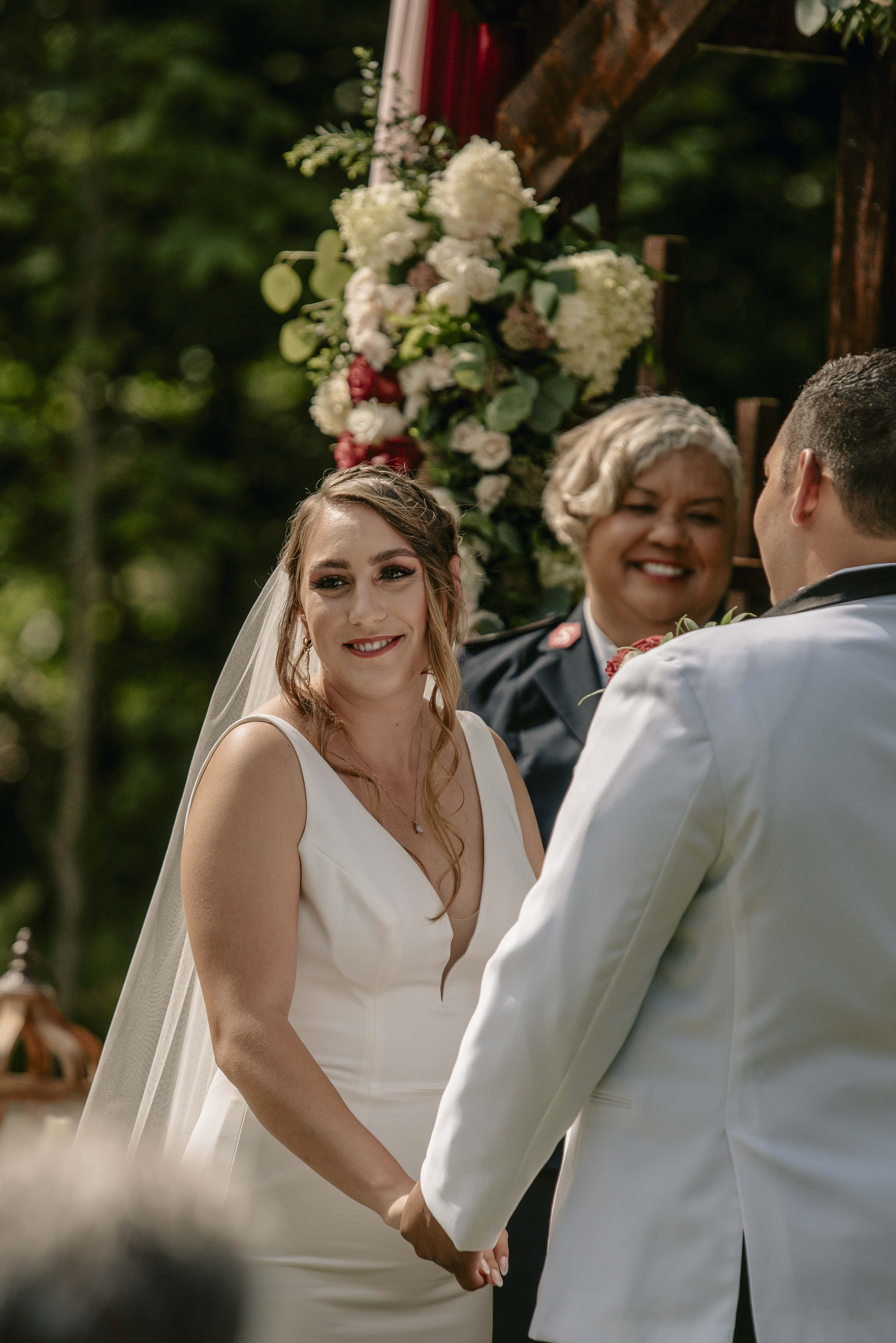 Bride smiles during ceremony at an Upstate New York Wedding in the Hudson Valley