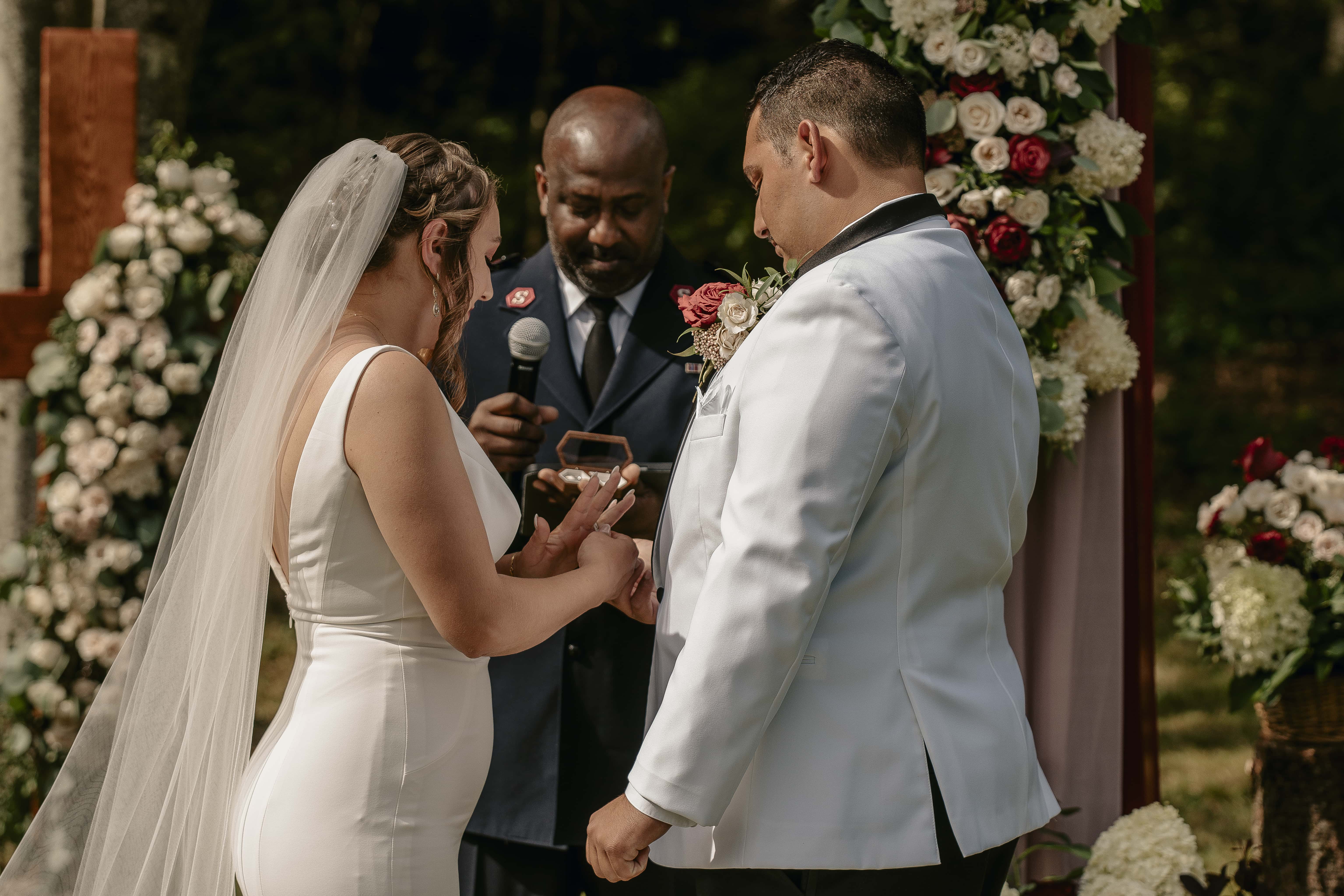 Groom puts ring on bride during ceremony at an Upstate New York Wedding in the Hudson Valley