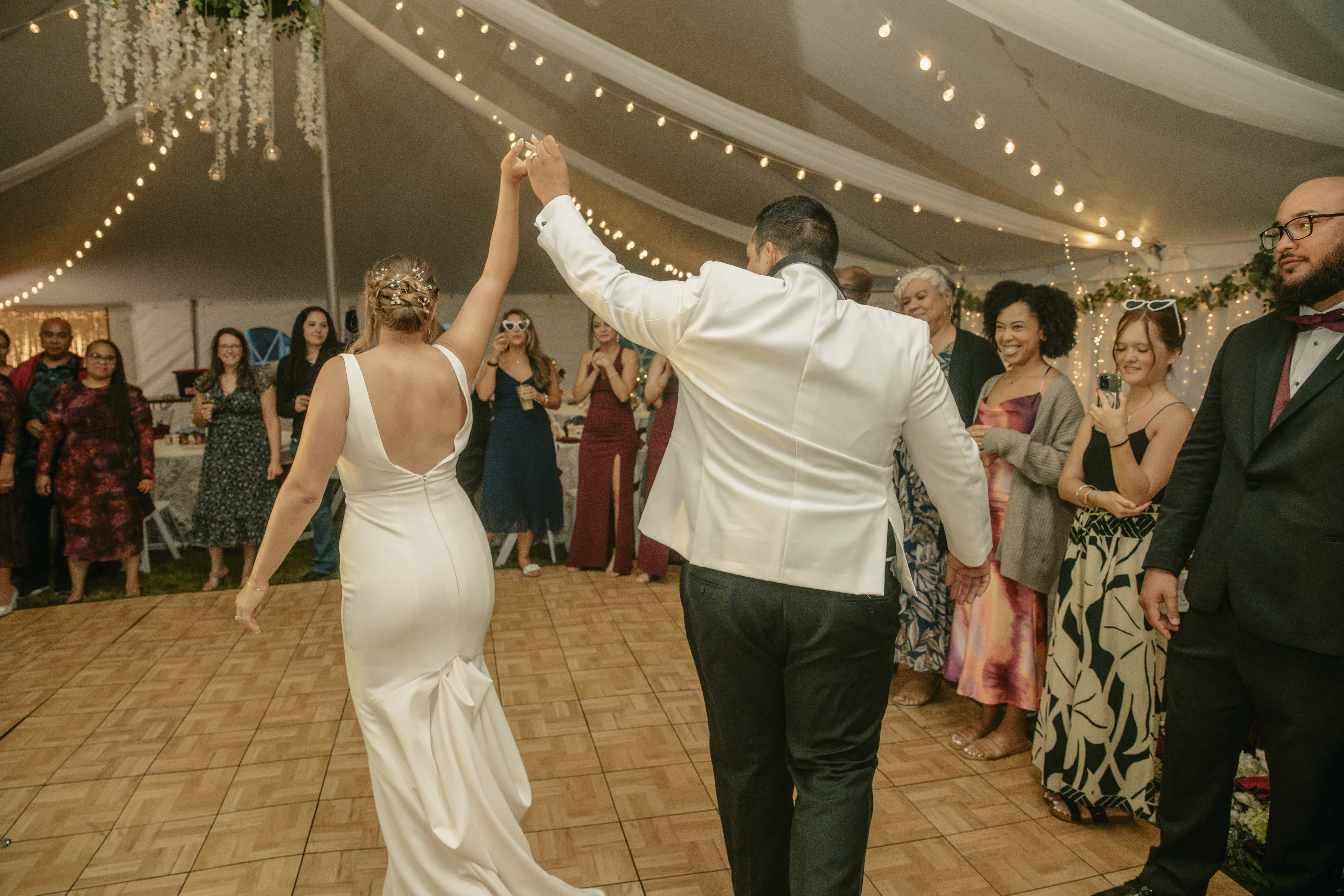 Groom raises brides hand during reception at an Upstate New York Wedding in the Hudson Valley