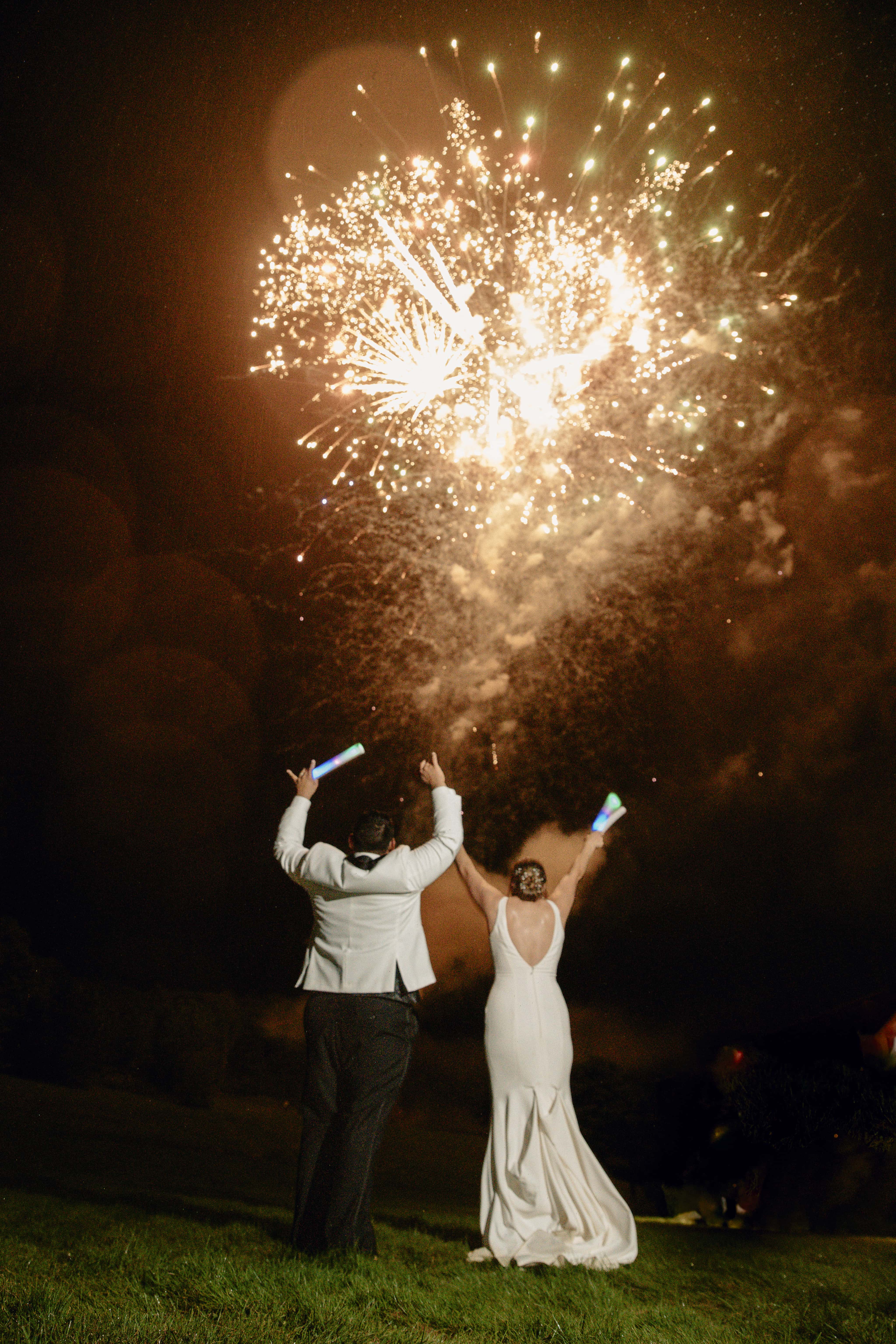 Bride and Groom celebrate with orange fireworks at an Upstate New York Wedding in the Hudson Valley