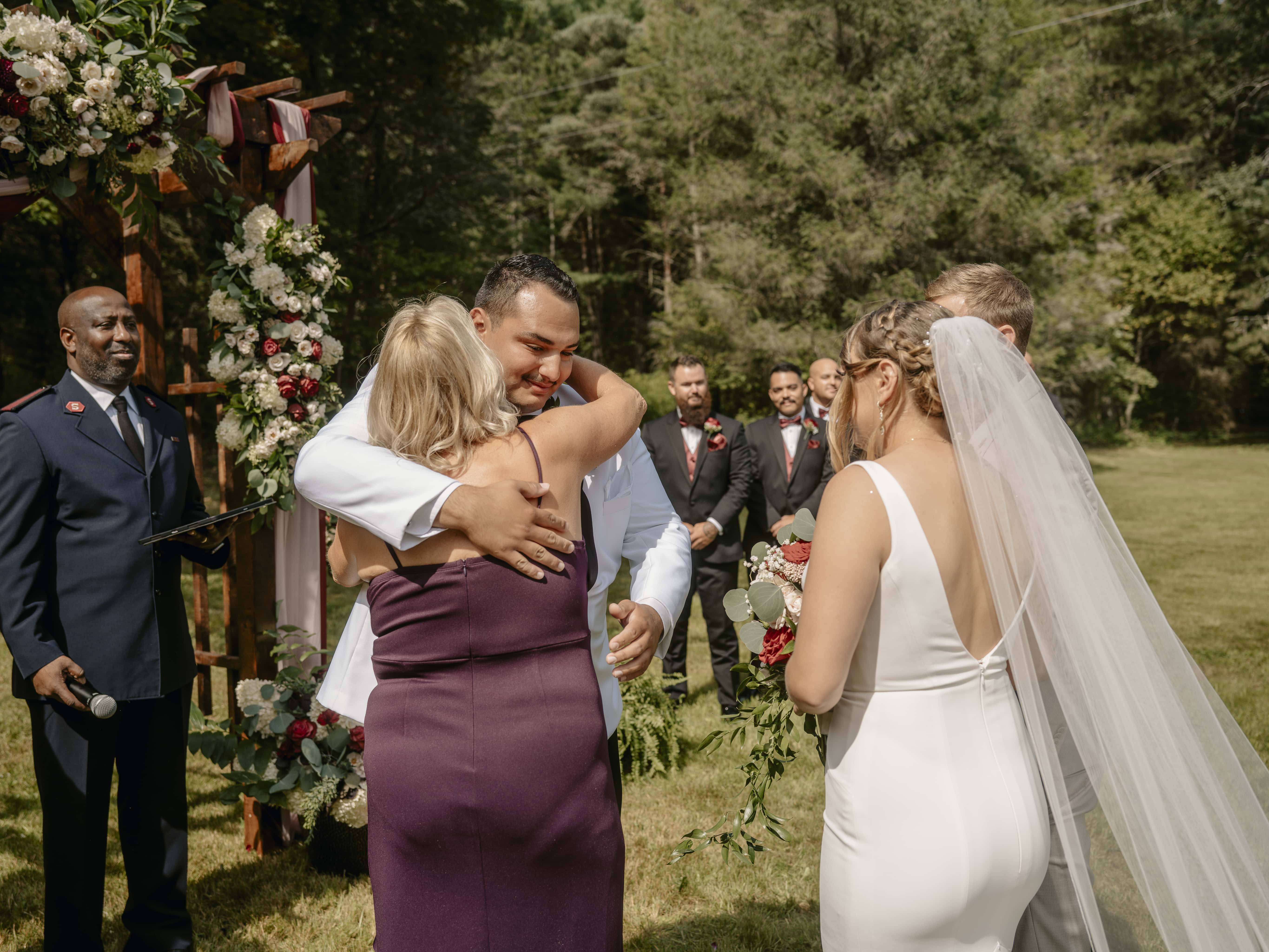 Groom hugs mother of bride during ceremony at an Upstate New York Wedding in the Hudson Valley