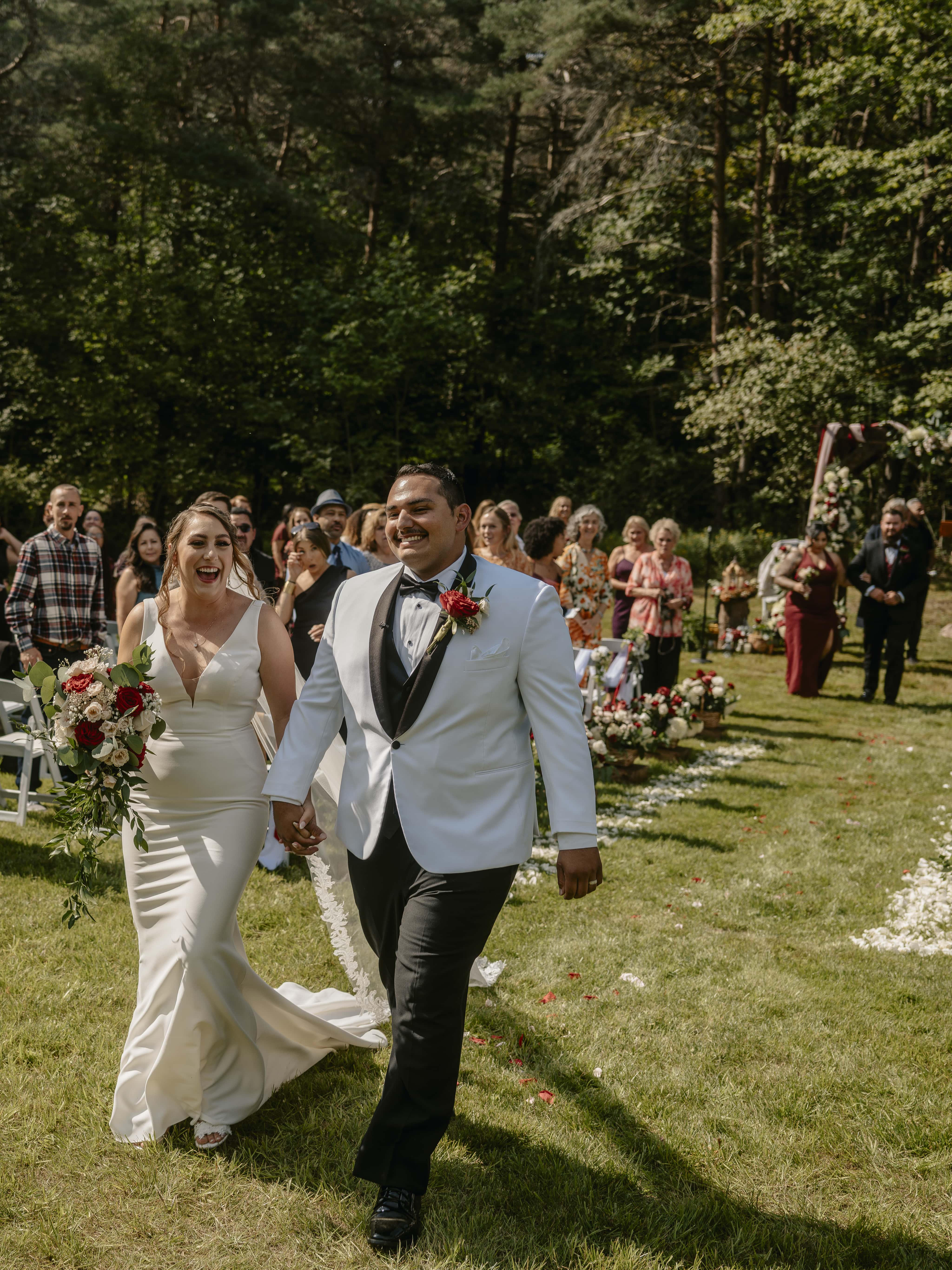 Bride and Groom Smile Down Aisle during processional at an Upstate New York Wedding in the Hudson Valley