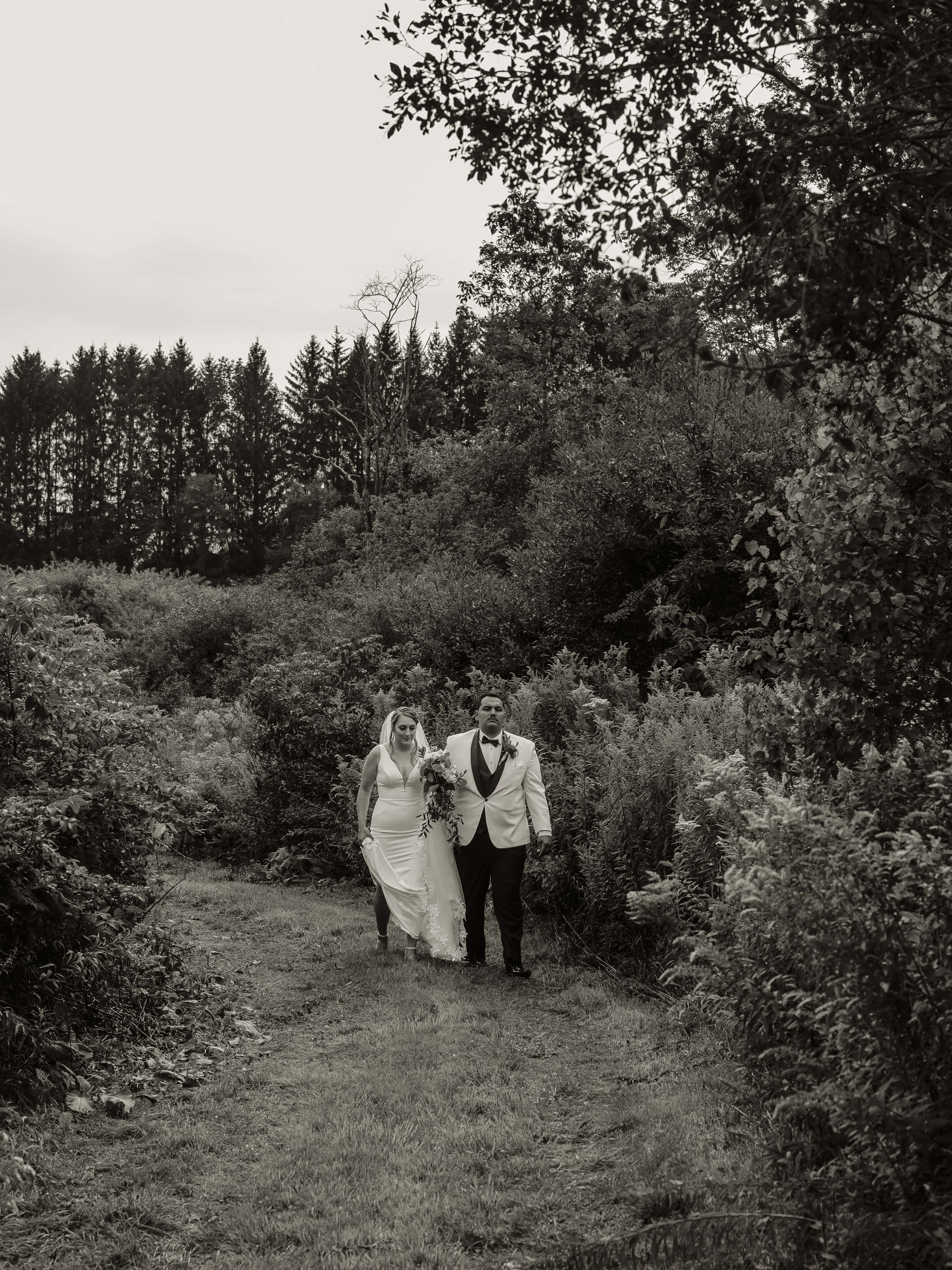 Black and White Photo of Bride and Groom walking at an Upstate New York Wedding in the Hudson Valley