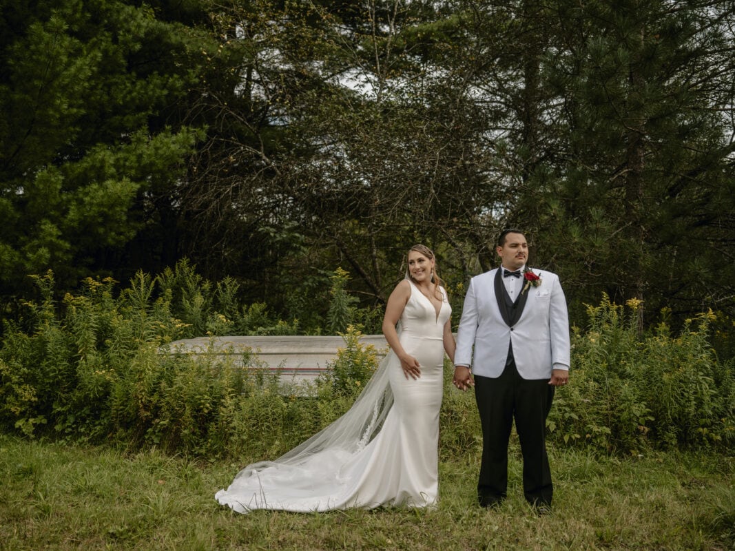 bride and Groom pose by Boat at an Upstate New York Wedding in the Hudson Valley