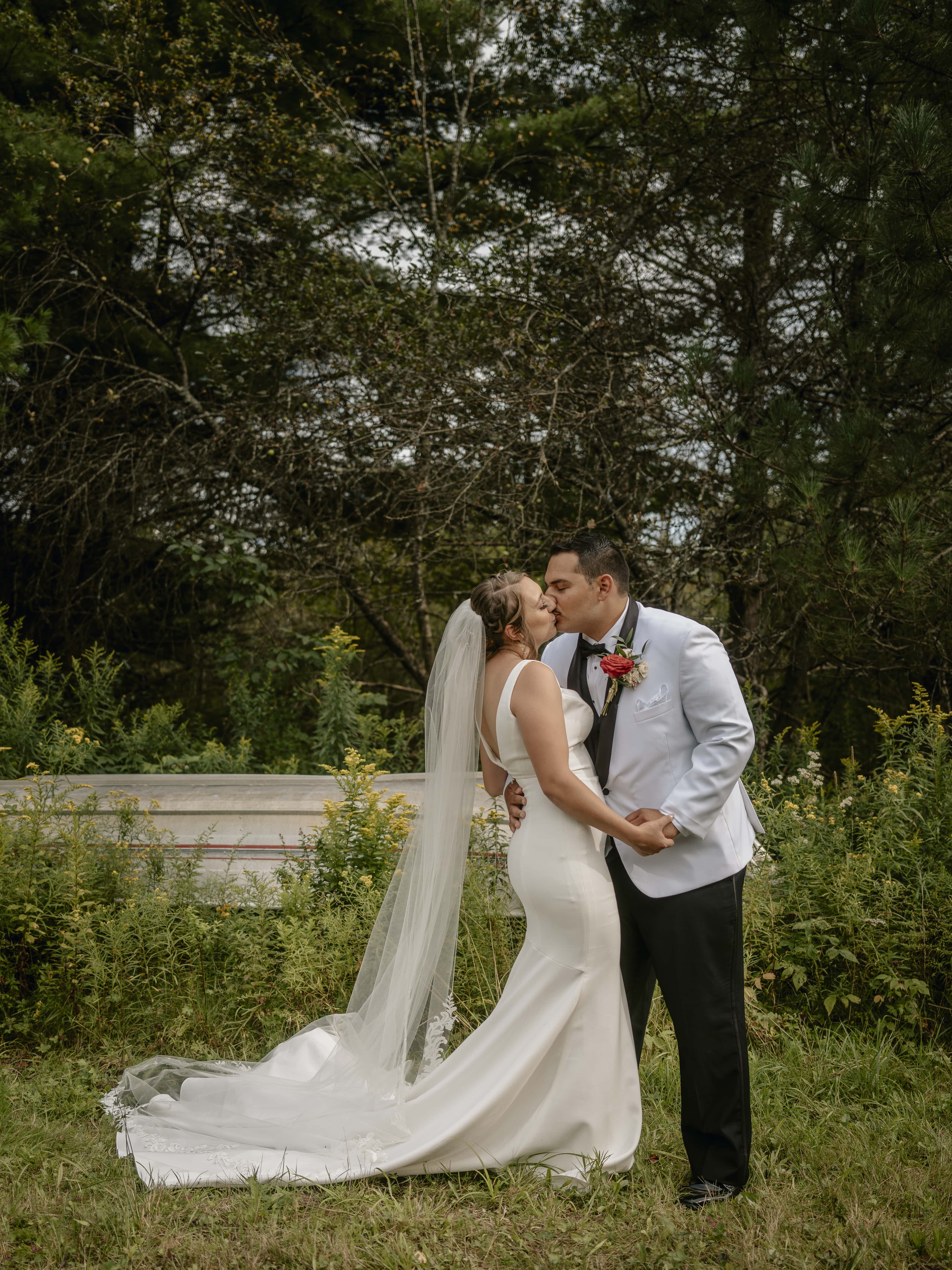 Bride and Groom Kiss by Boat at an Upstate New York Wedding in the Hudson Valley